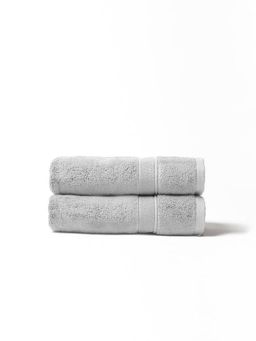 Light grey hand towels folded with white background 