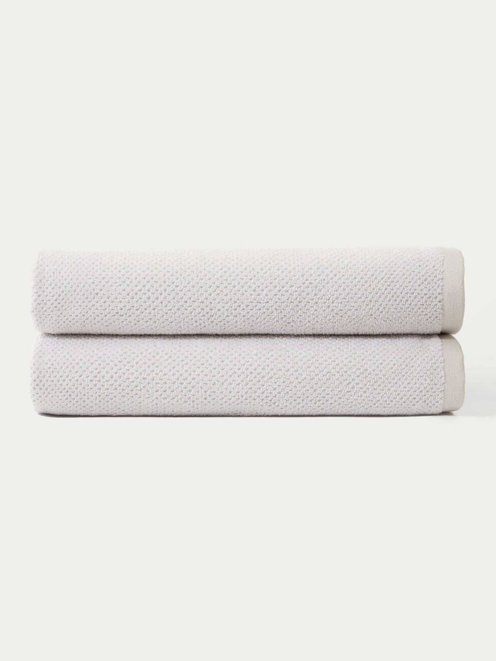 Nantucket Bath Sheets in the color Heathered Light Grey. The bath sheets are neatly folded. The photo of the bath sheets was taken with a white background.
