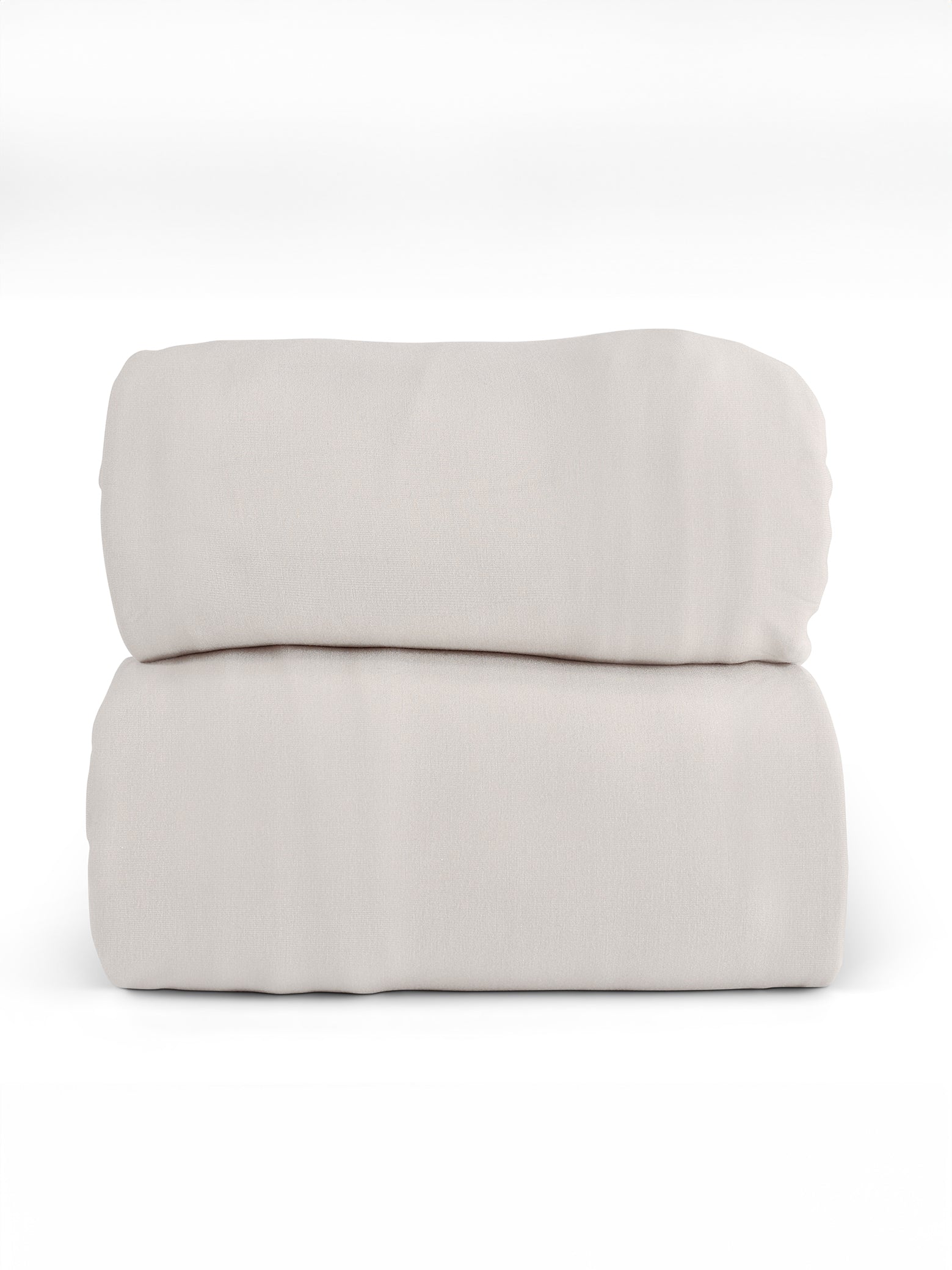 A neatly folded Bamboo Jersey Sheet Set by Cozy Earth in a light beige color is stacked in two layers against a white background. The sheets have a smooth texture and appear soft and plush.