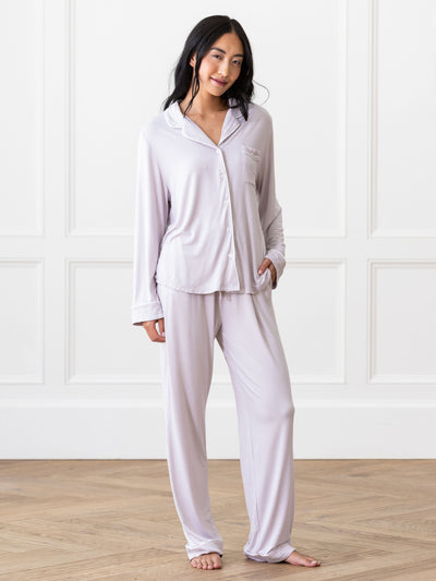 Lilac Long Sleeve Pajama Set modeled by a woman. The photo was taken in a high contrast setting, showing off the colors and lines of the pajamas. |Color:Lilac