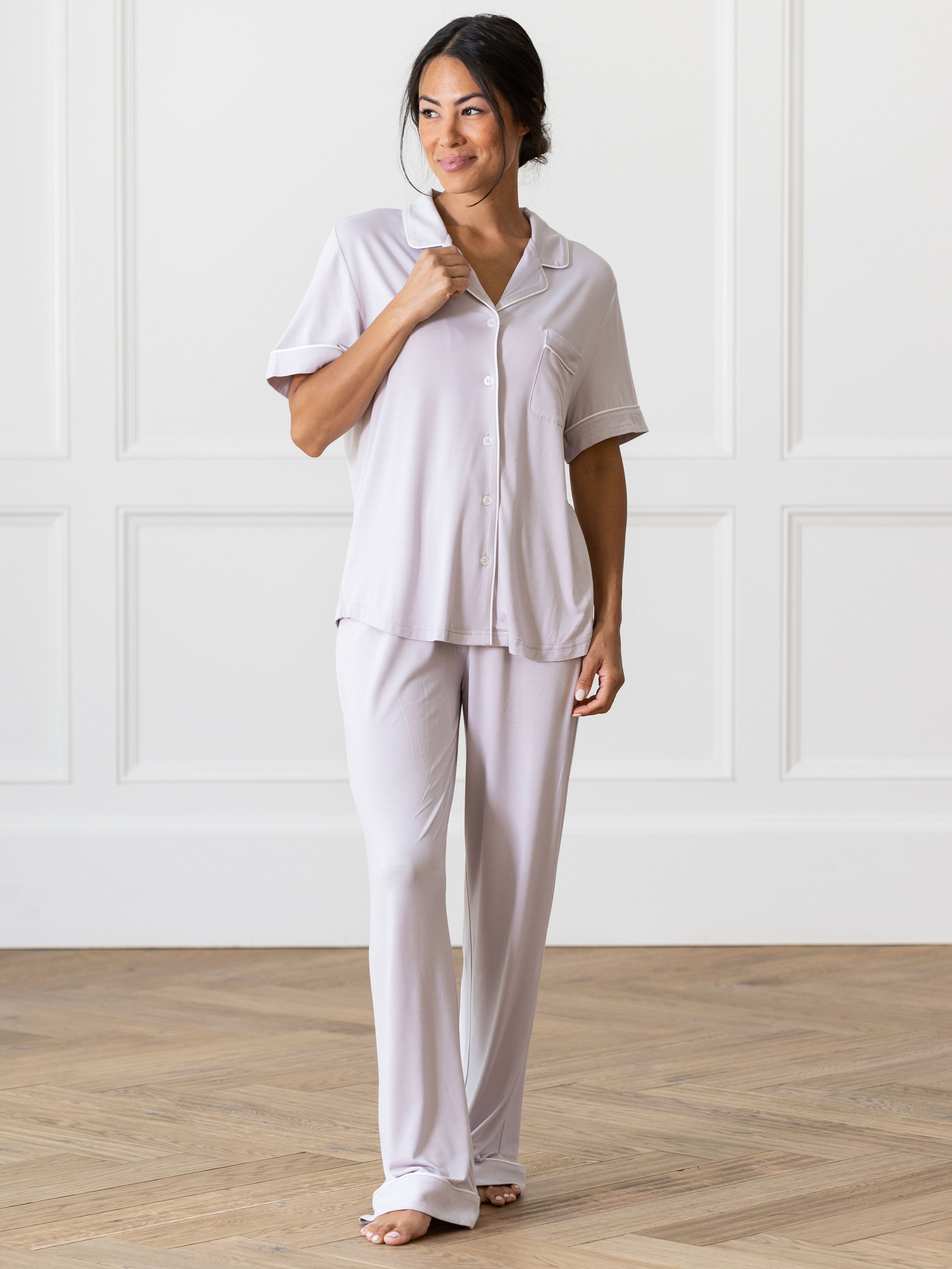 Lilac Short Sleeve & Pant Bamboo Pajama Set modeled by a woman. The photo was taken in a high contrast setting, showing off the colors and lines of the pajamas. |Color: Lilac