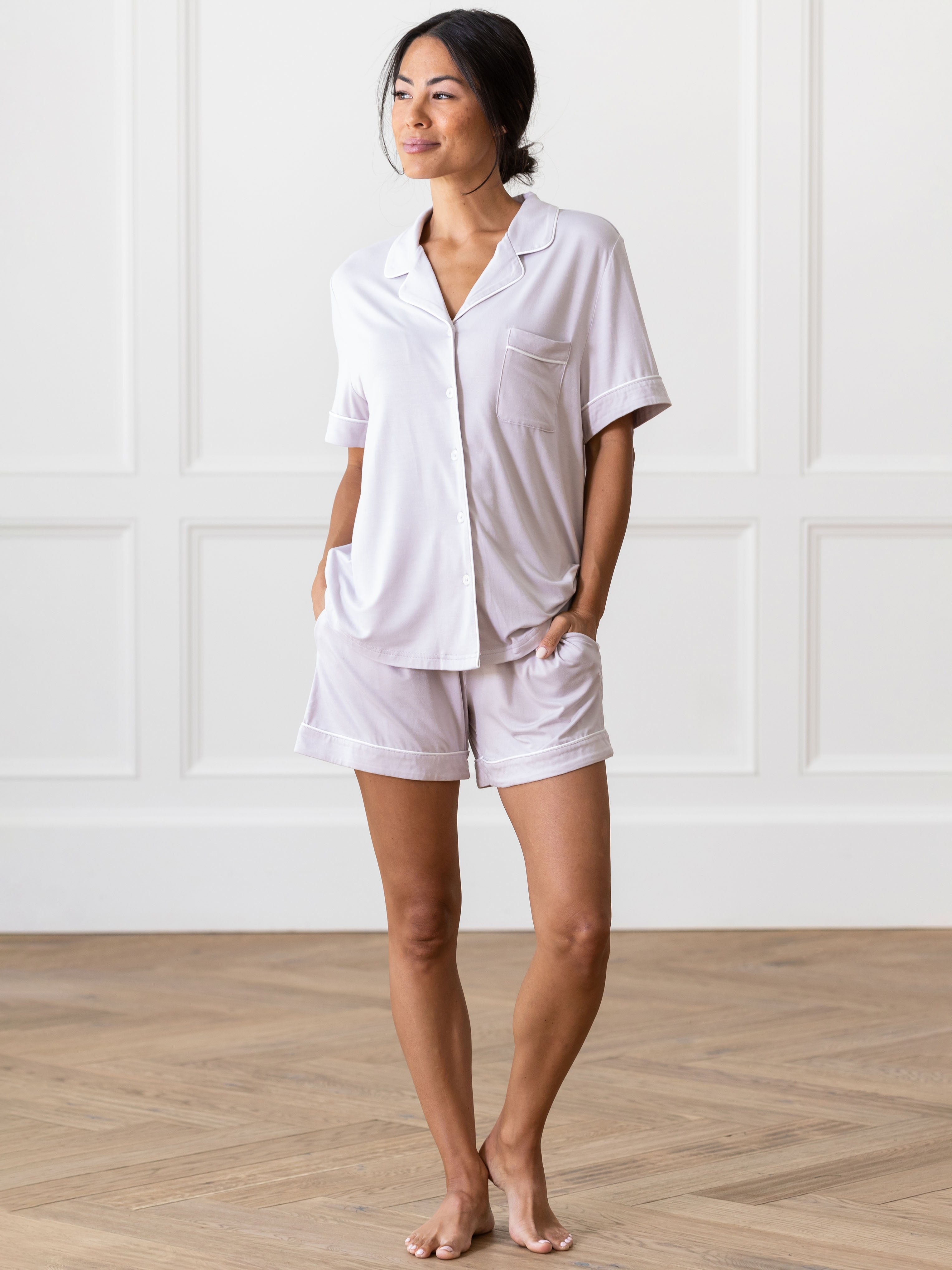 Lilac Short Sleeve Pajama Set modeled by a woman. The photo was taken in a light setting, showing off the colors and lines of the pajamas. 