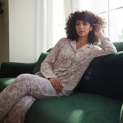 Woman sitting on couch in lilac toile pajama set |Color:Lilac Toile