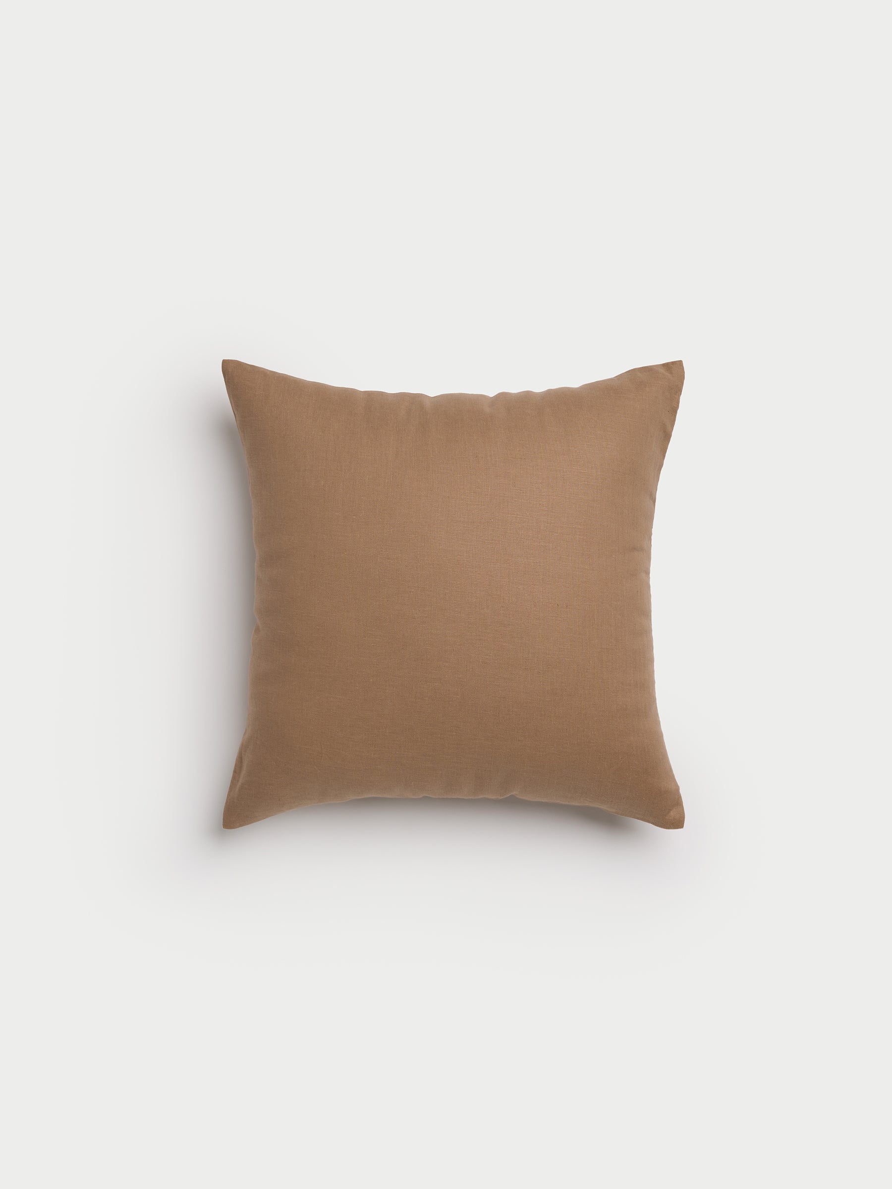 A Linen Throw Pillow by Cozy Earth, featuring a smooth brown texture against a plain white background. |Color:Maple|Size:20" x 20"