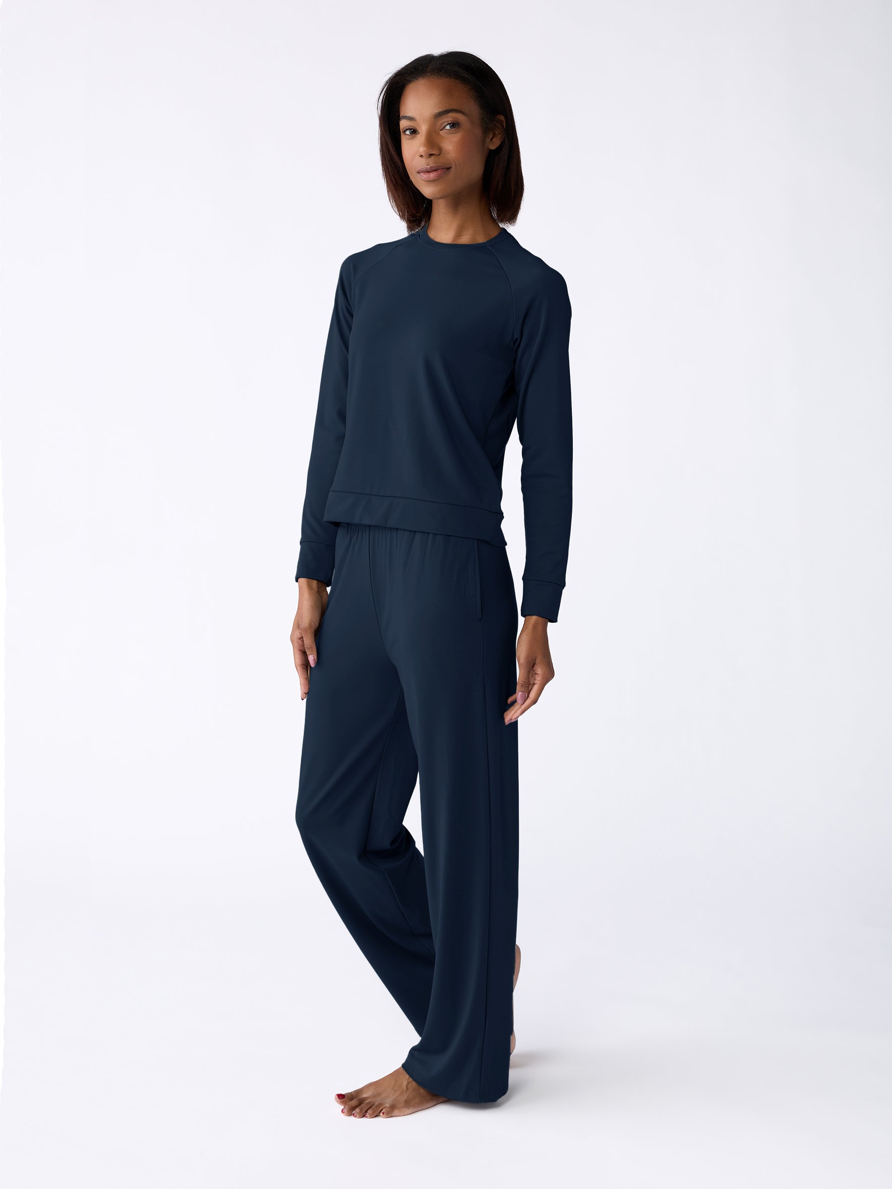 A person is barefoot against a plain white background wearing the Cozy Earth Women's Ultra-Soft Bamboo Wide Leg Pull On Pant & Pullover Crew Set in dark blue. |Color:Navy