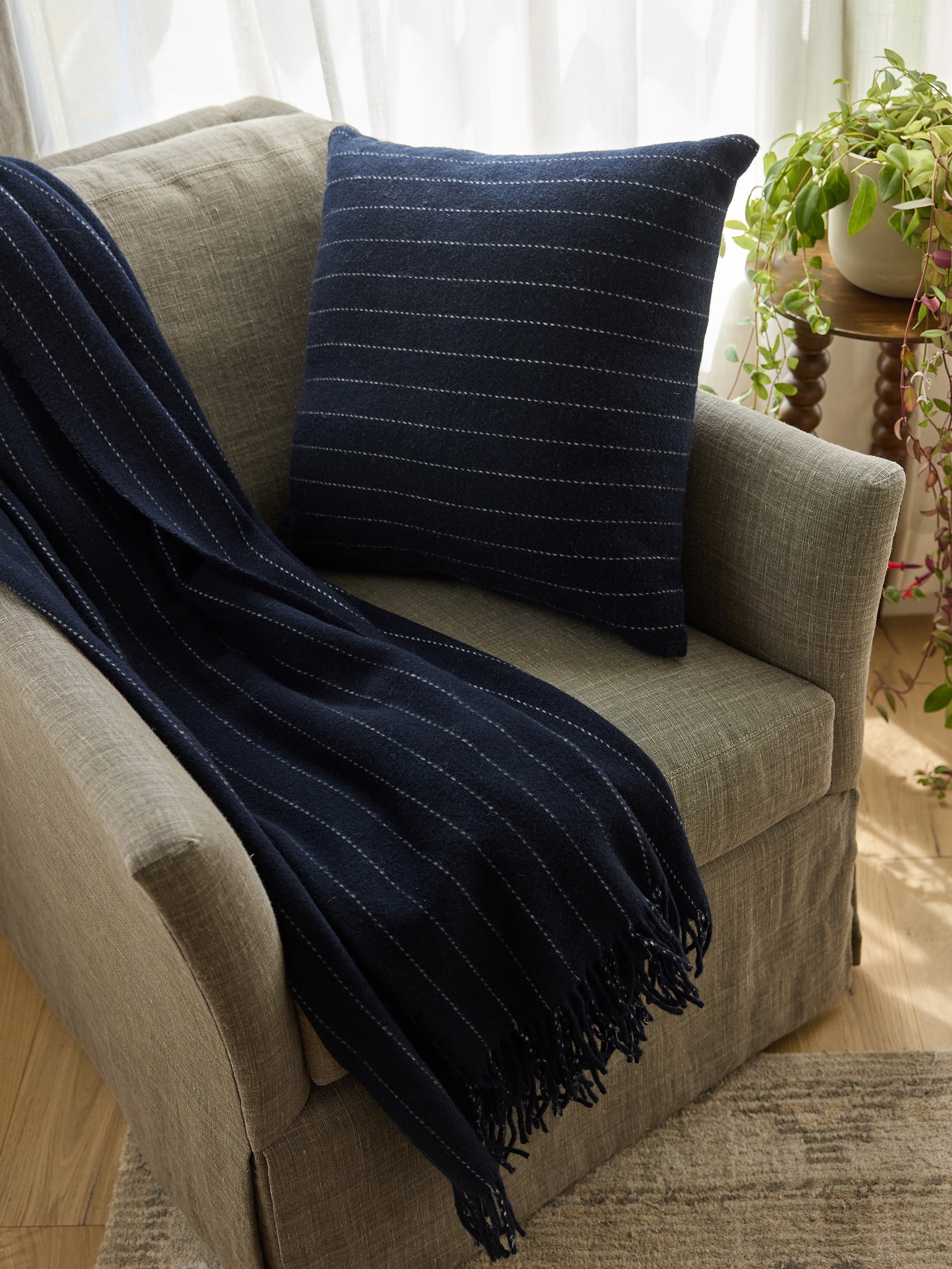 Florence pillow and blanket sitting on accent chair 