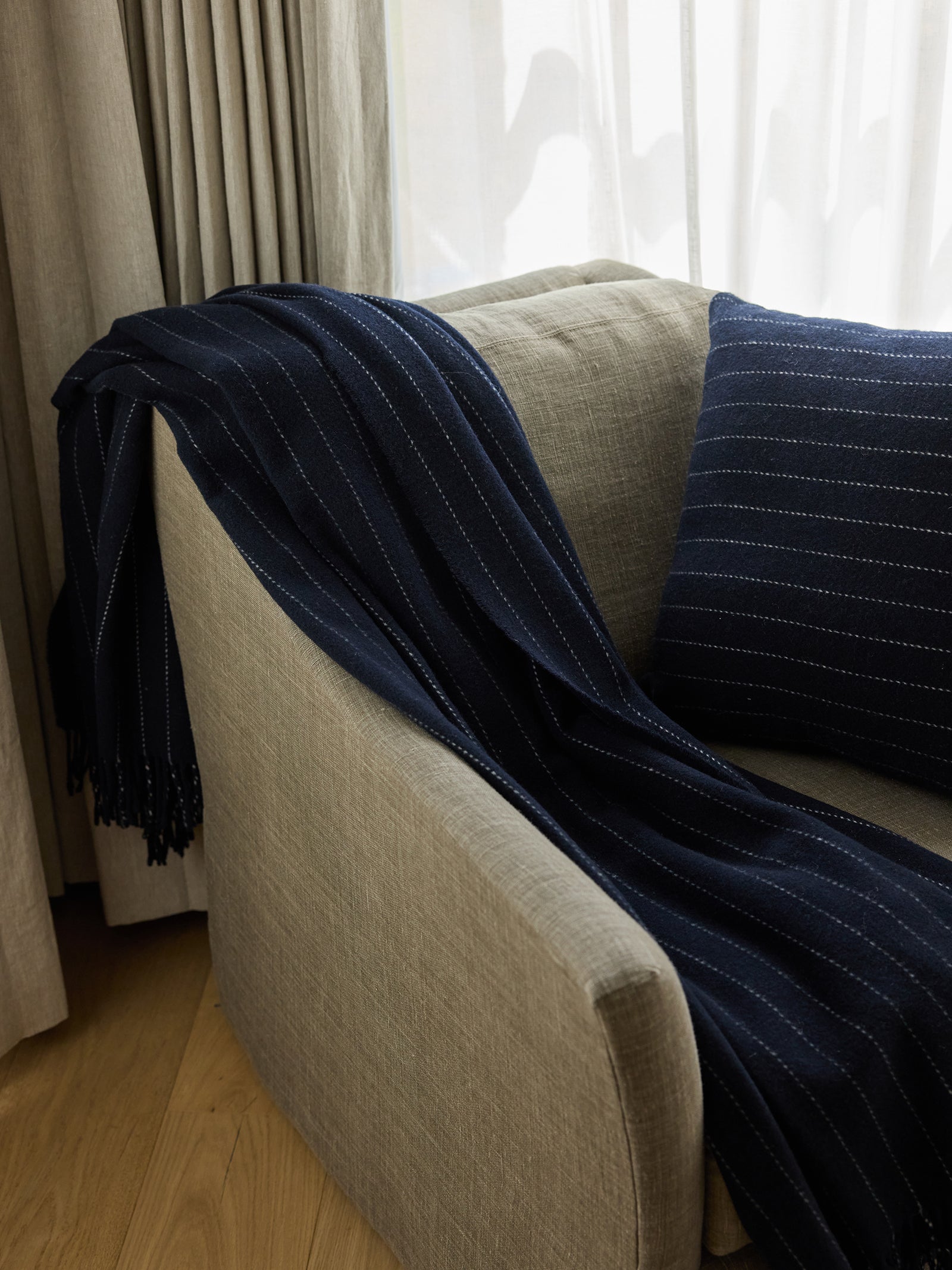 Navy florence blanket draped over chair 