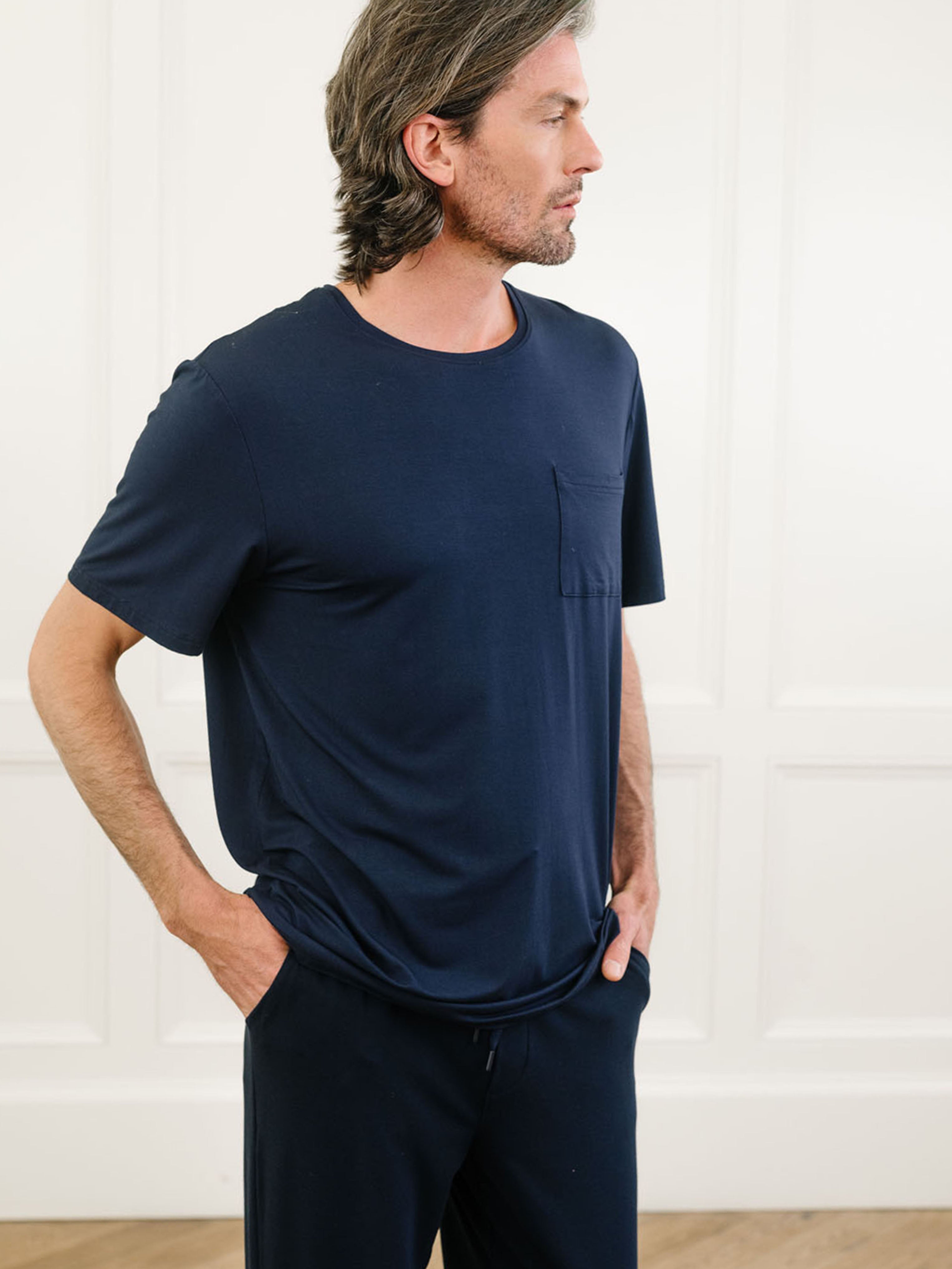 Navy Men's Stretch-Knit Bamboo Lounge Tee. A man is wearing the lounge tee in a well lit home.|Color:Navy