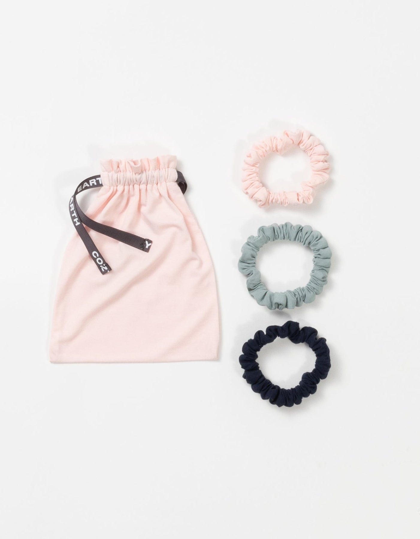 Cozy Earth Bamboo Stretch Knit Skinny Scrunchies in Navy, Brook, and Blossom pictured with storage bag on a white background. |Color:Navy/Brook/Blossom
