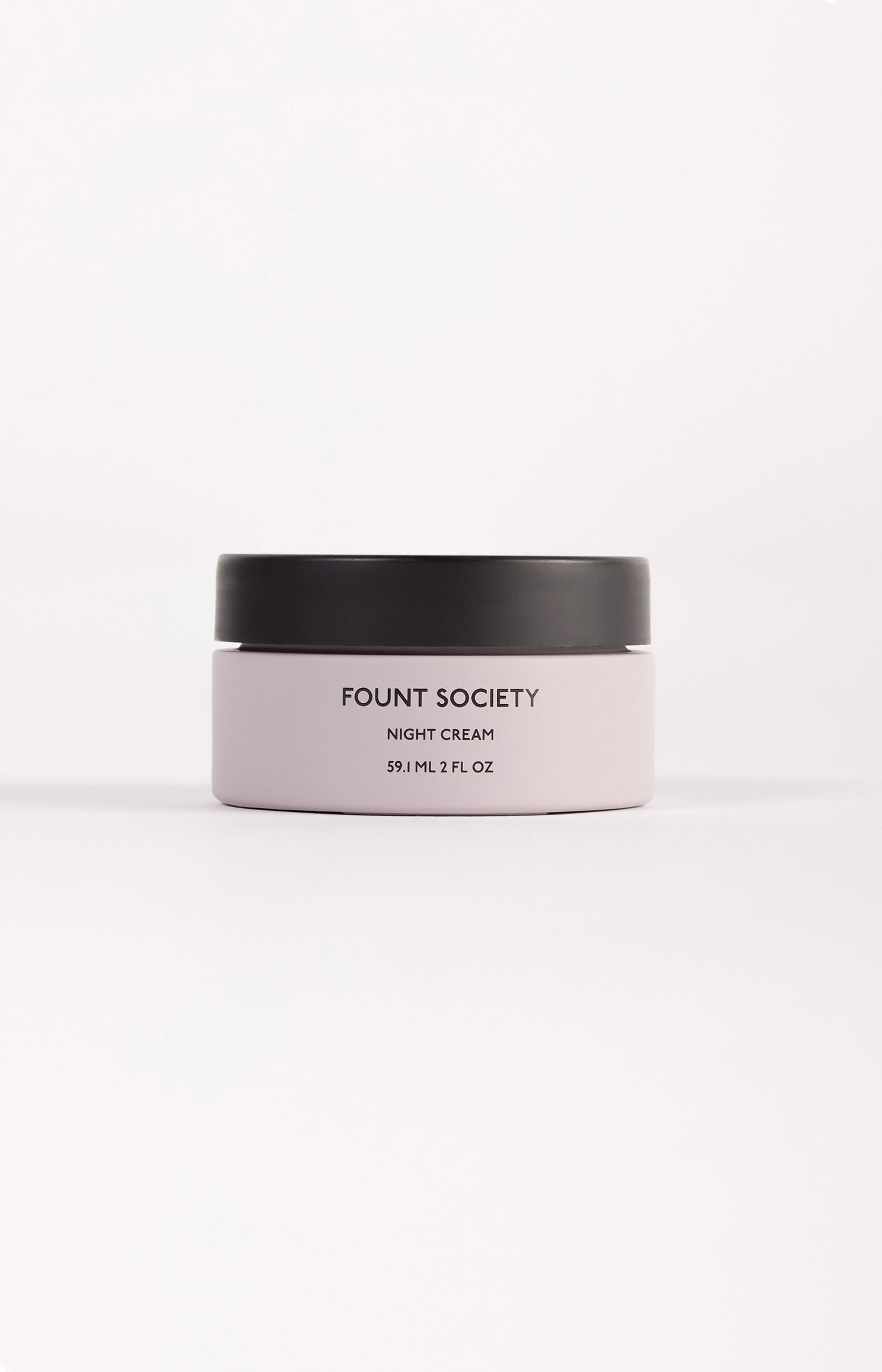 The Fount Society Night Cream container sits in front of a white background. 