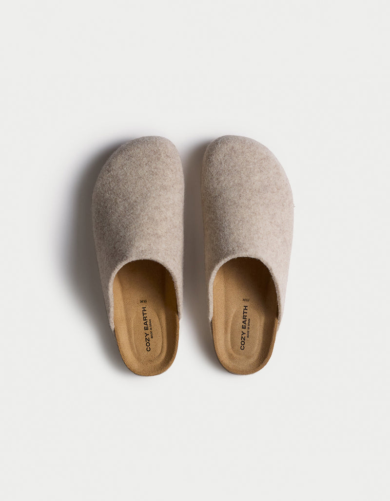 A top-down view of Cozy Earth's Lakehouse Clog, a pair of beige slip-on slippers with a soft texture and simple rounded design, set against a white background.