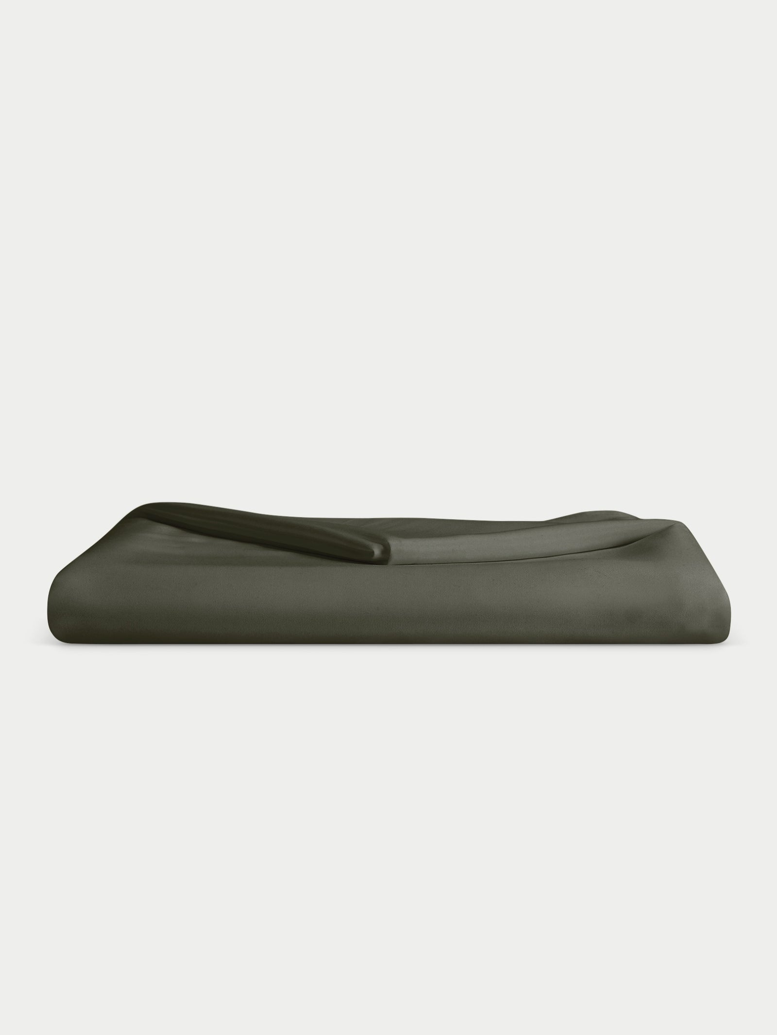 A neatly folded Bamboo Flat Sheet in dark green, by Cozy Earth, set against a light gray background. 