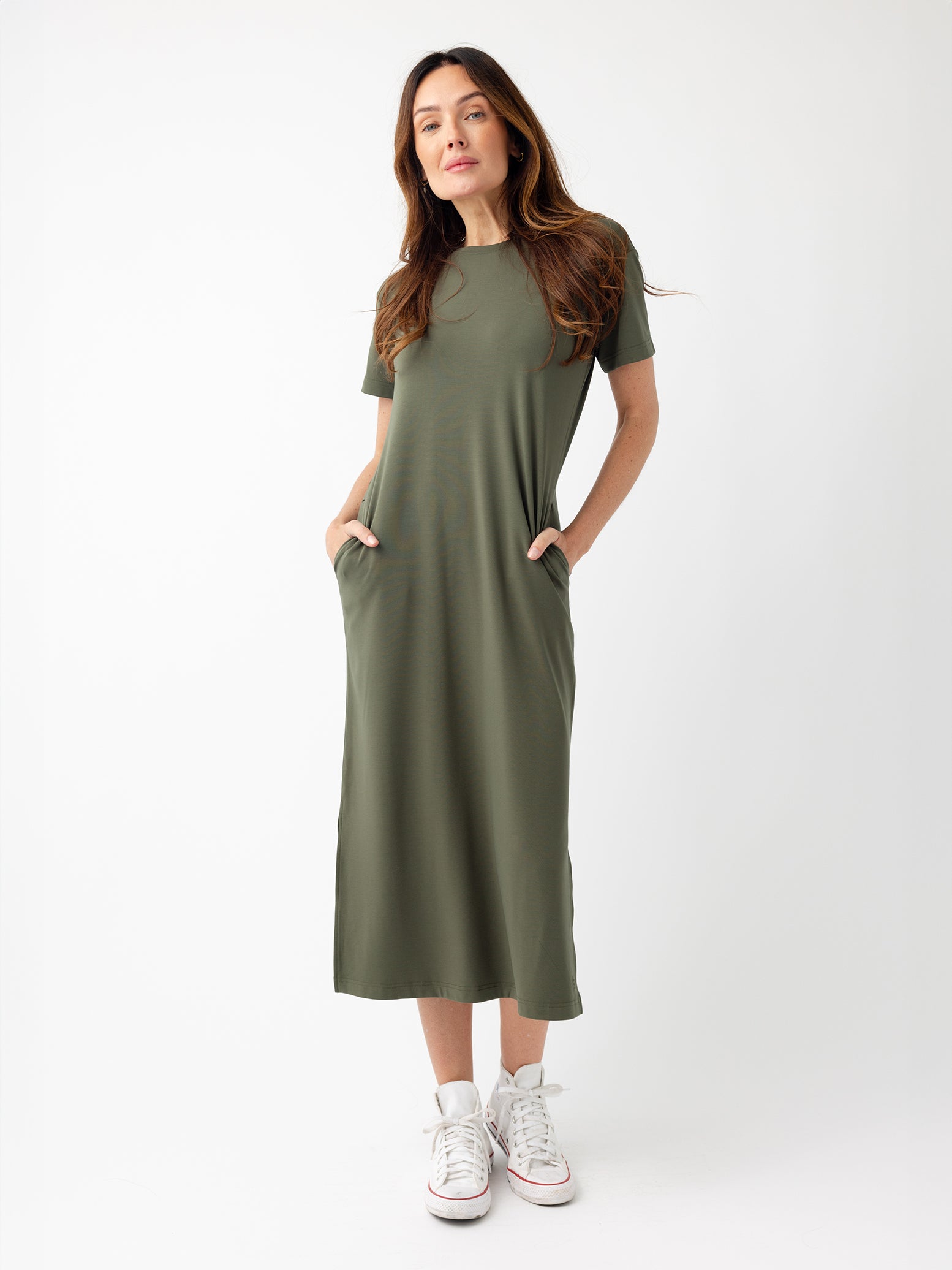 Woman in olive midi dress with white background 