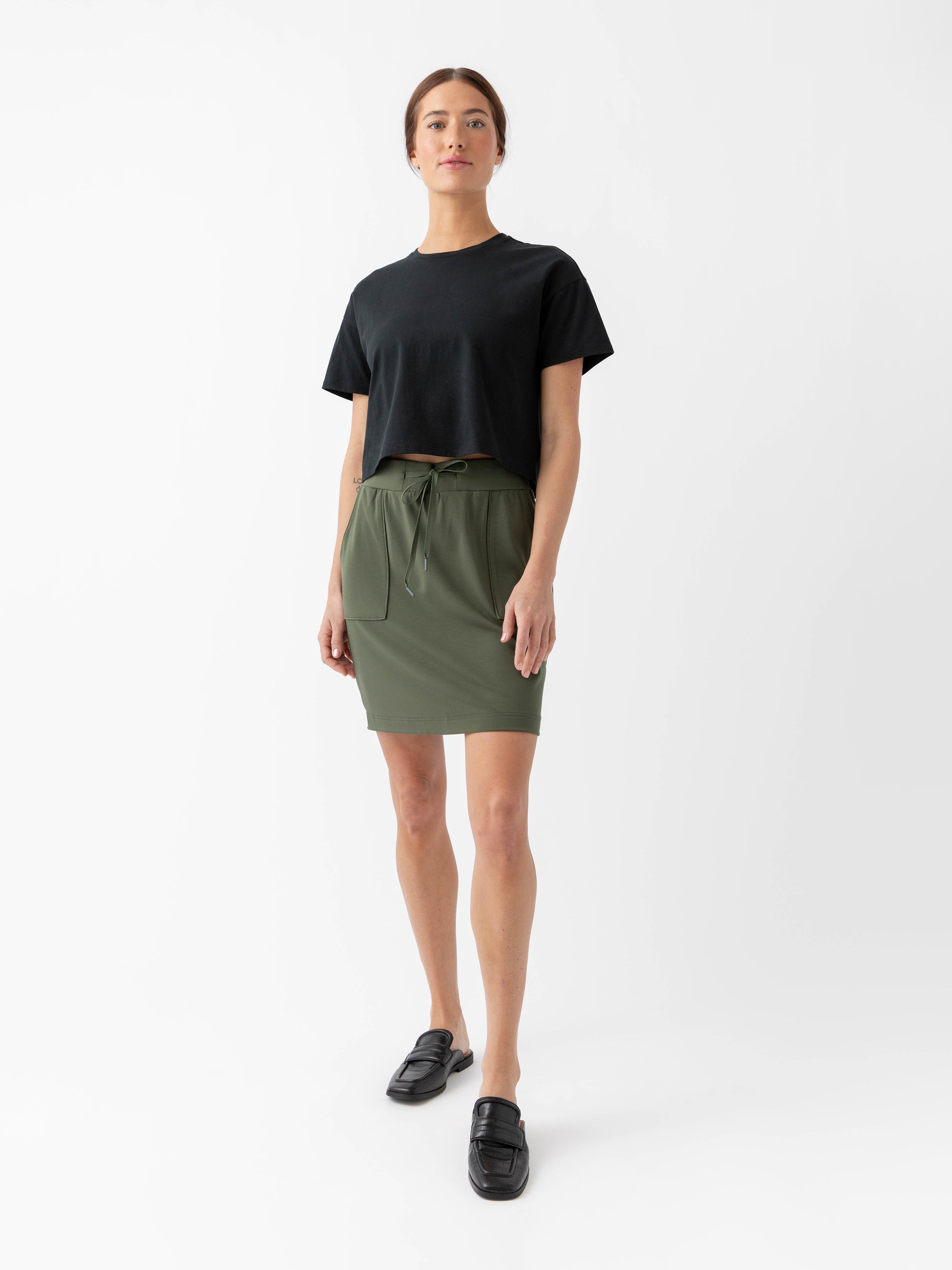 Person wearing a Cozy Earth Brushed Bamboo Patch Pocket Skirt in green on a white background 