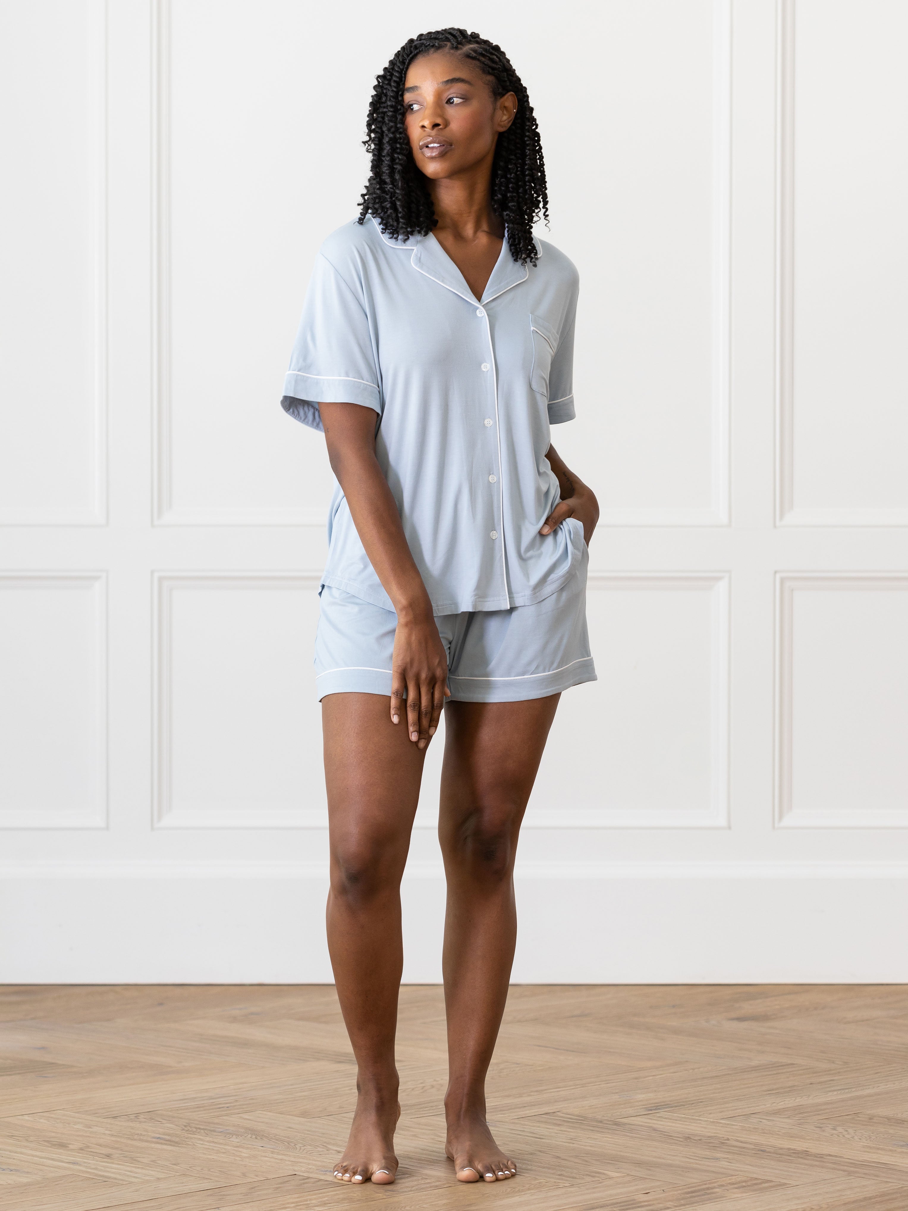 Powder Blue Short Sleeve Pajama Set modeled by a woman. The photo was taken in a light setting, showing off the colors and lines of the pajamas. |Color:Powder Blue