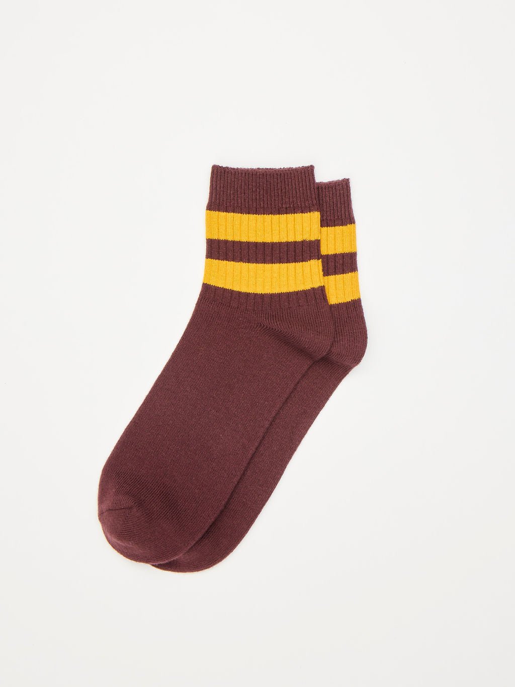 The Women's Sadie Sock by Cozy Earth is displayed flat on a white background, featuring a burgundy color with two yellow stripes near the ankle. |Color:Burgundy/Goldenrod