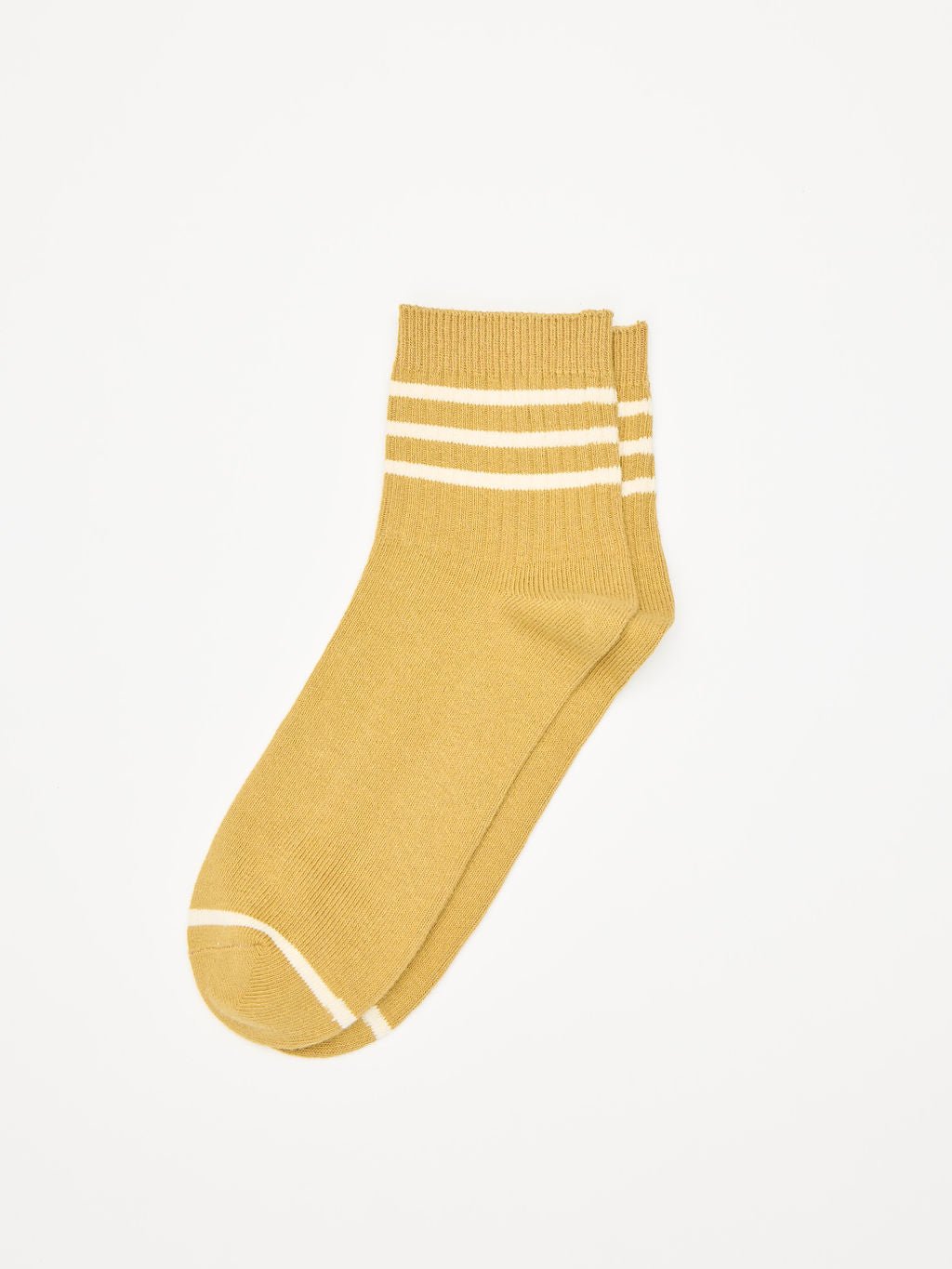 The Women's Sadie Sock by Cozy Earth is a pair of mustard yellow ankle socks featuring two white stripes near the cuff and a white line around the toe area, showcased on a plain white background. 