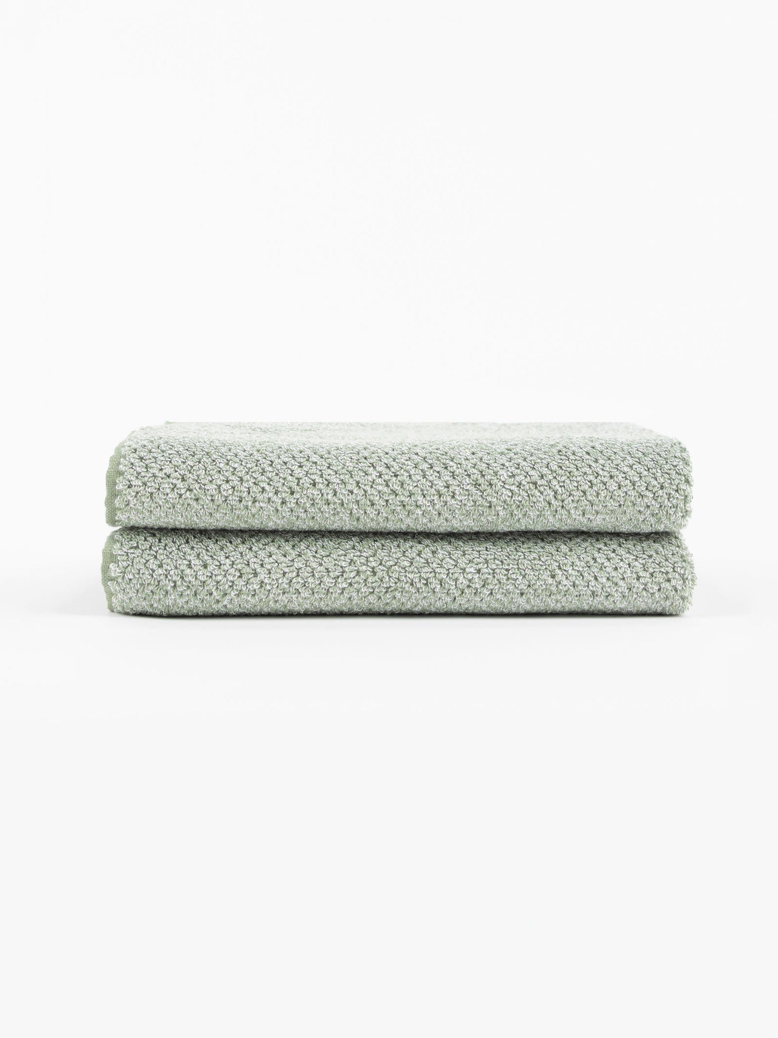 A pair of Nantucket Hand Towels in Heathered Clay is stacked in front of a white background. |Color:Heathered Sage