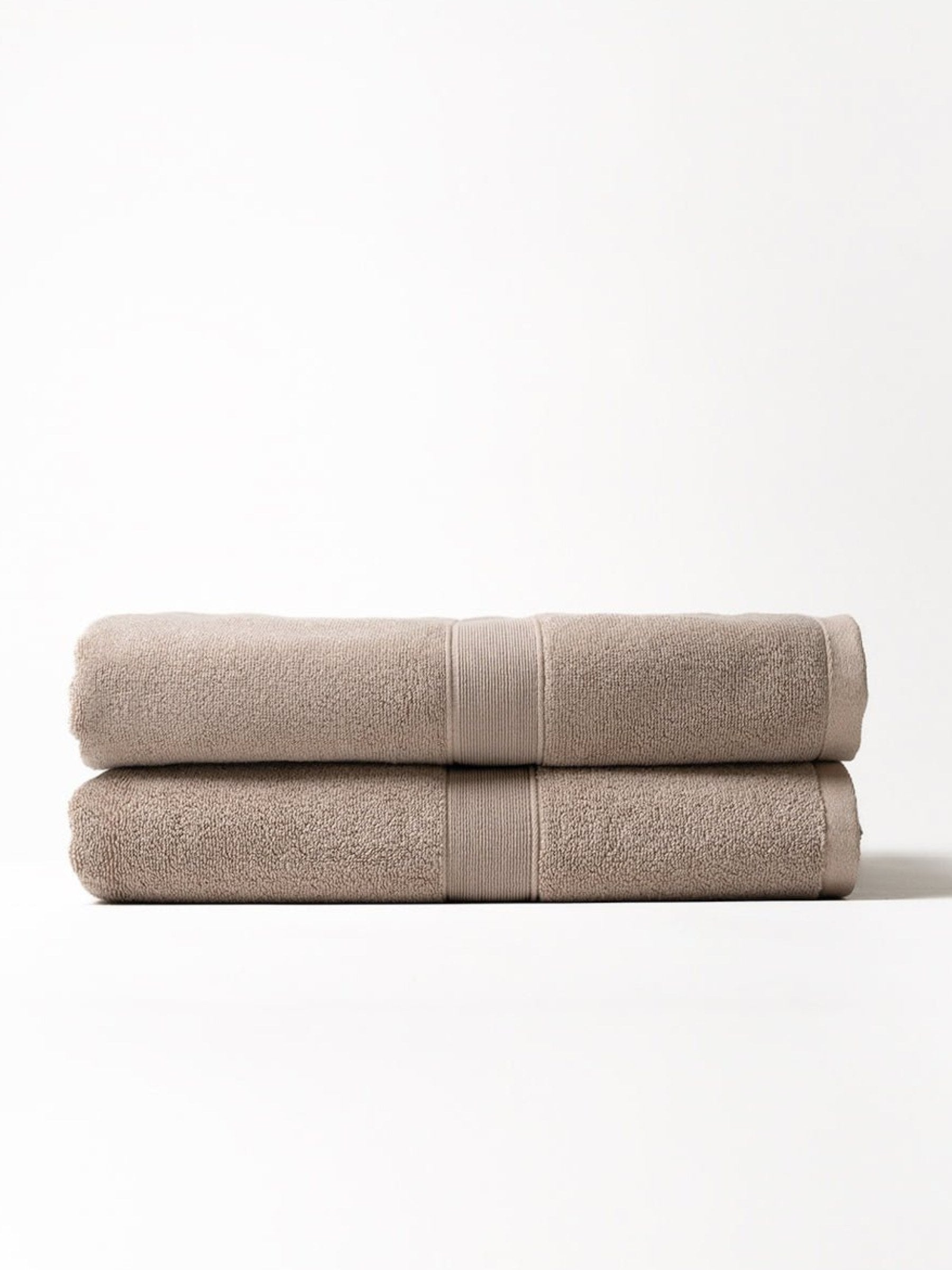Two luxe bath sheets folded with white background 