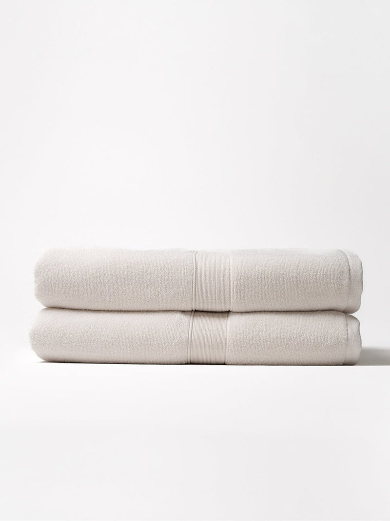 Two luxe bath sheets folded with white background