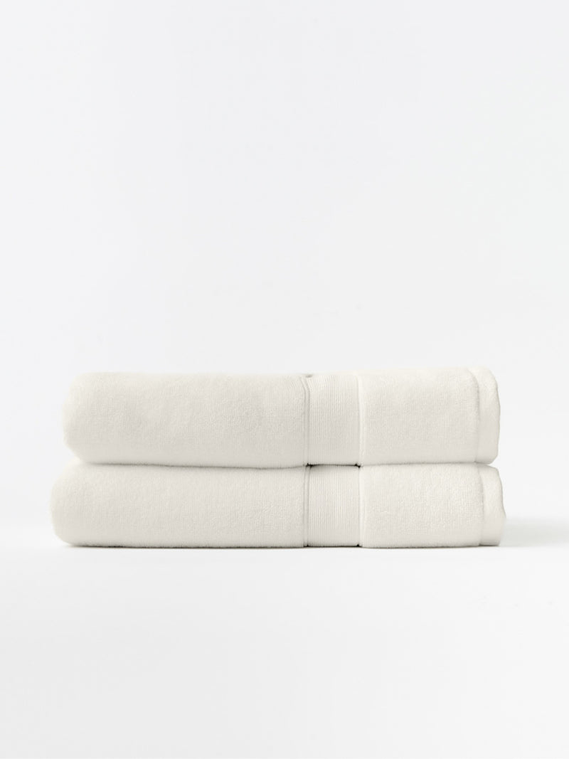 Seashell luxe bath towels folded with white background