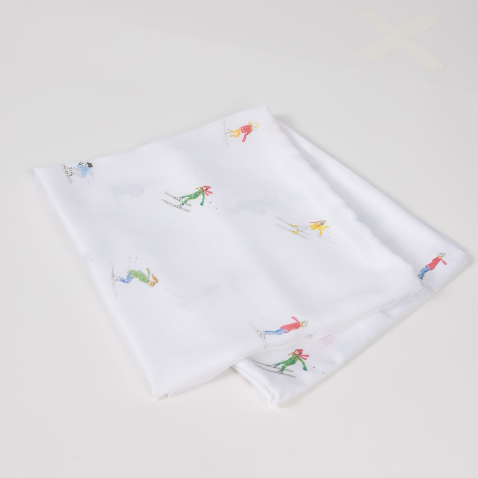 Two folded pillowcases with skiers on them standard/king/body 