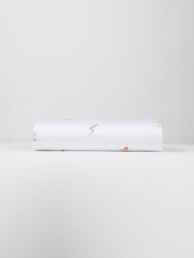 A neatly folded Bamboo Duvet Cover by Cozy Earth, showcasing small, colorful illustrations of people engaged in various activities against a plain white background. |Color:Skiers