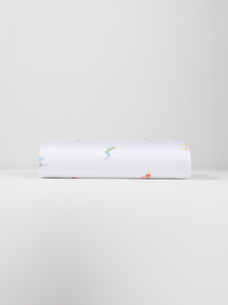 A neatly folded Bamboo Duvet Cover by Cozy Earth, showcasing small, colorful illustrations of people engaged in various activities against a plain white background.