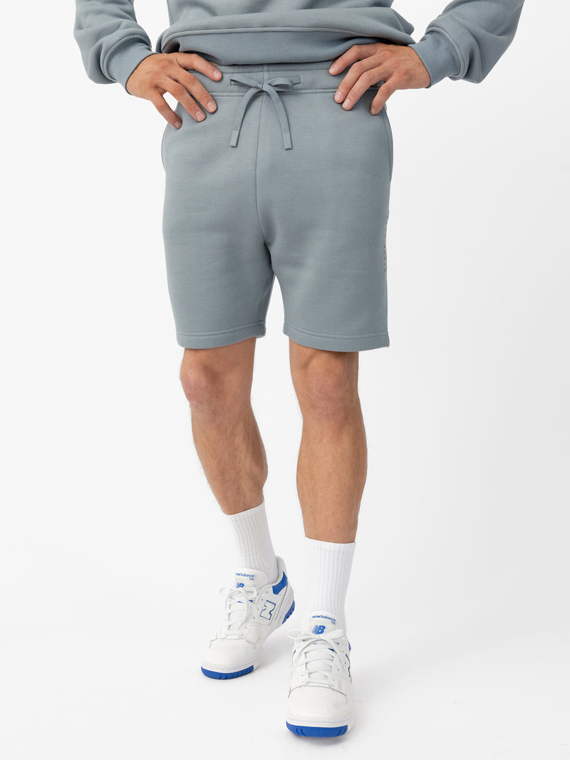 Man wearing Smokey Blue CityScape Shorts with white background