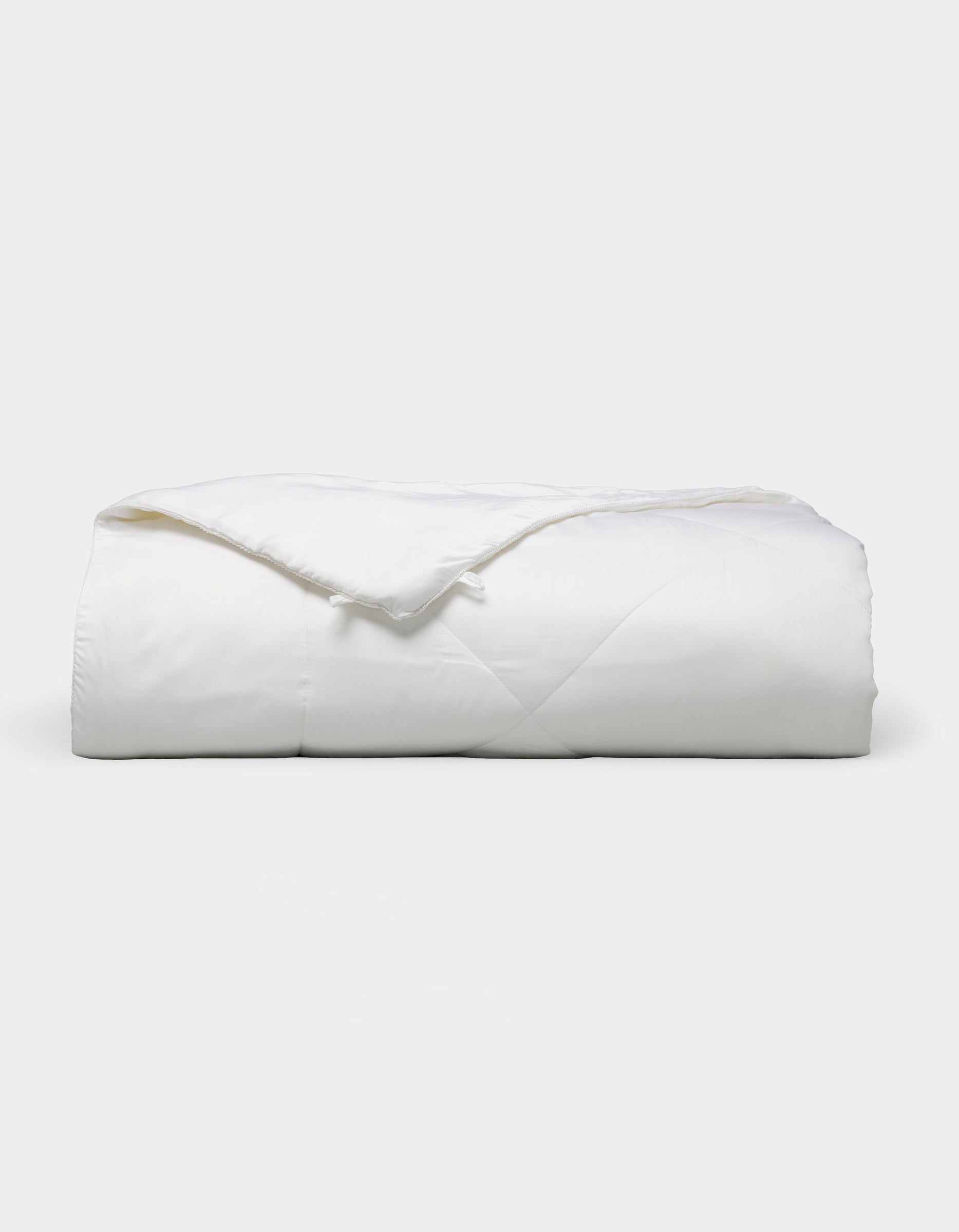 Bamboo viscose comforter meant to be paired with Charcoal, White, Driftwood, Oat, Light Grey, Walnut, Pacific Blue, Creme, Shore, Dove Grey, Peony, Lemonade, Laurel, Lavender, Classic Stripe in Pacific, Classic Stripe in Ebony, Classic Stripe in Laurel, River, or Mulberry sheets