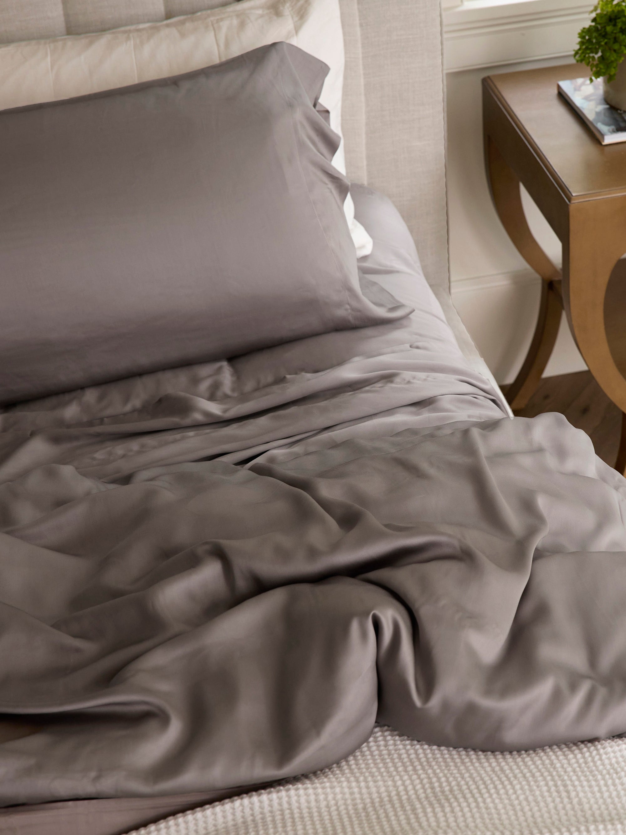 Unmade bed with stone bedding 