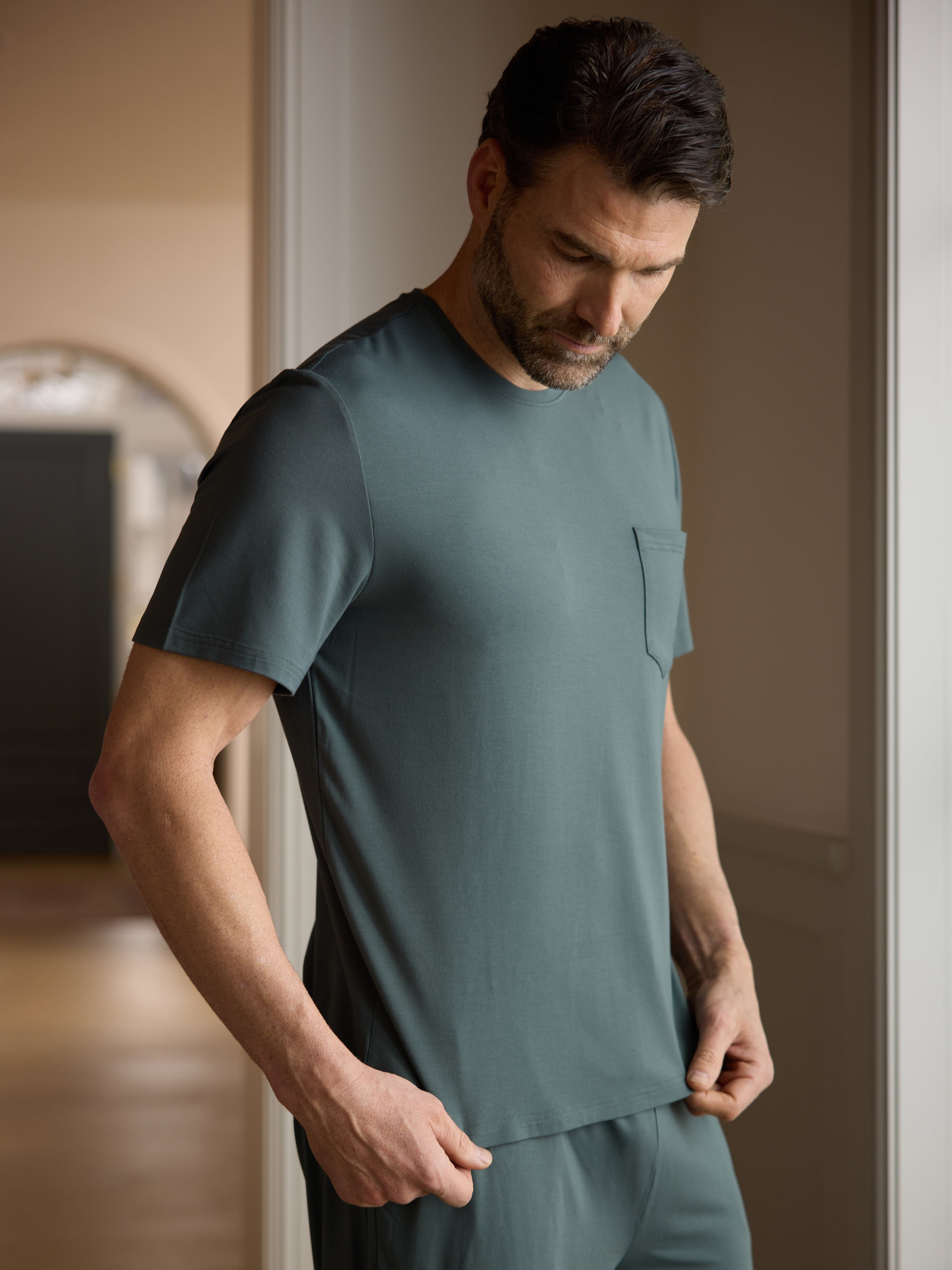 Man wearing storm pajama shirt in hallway 