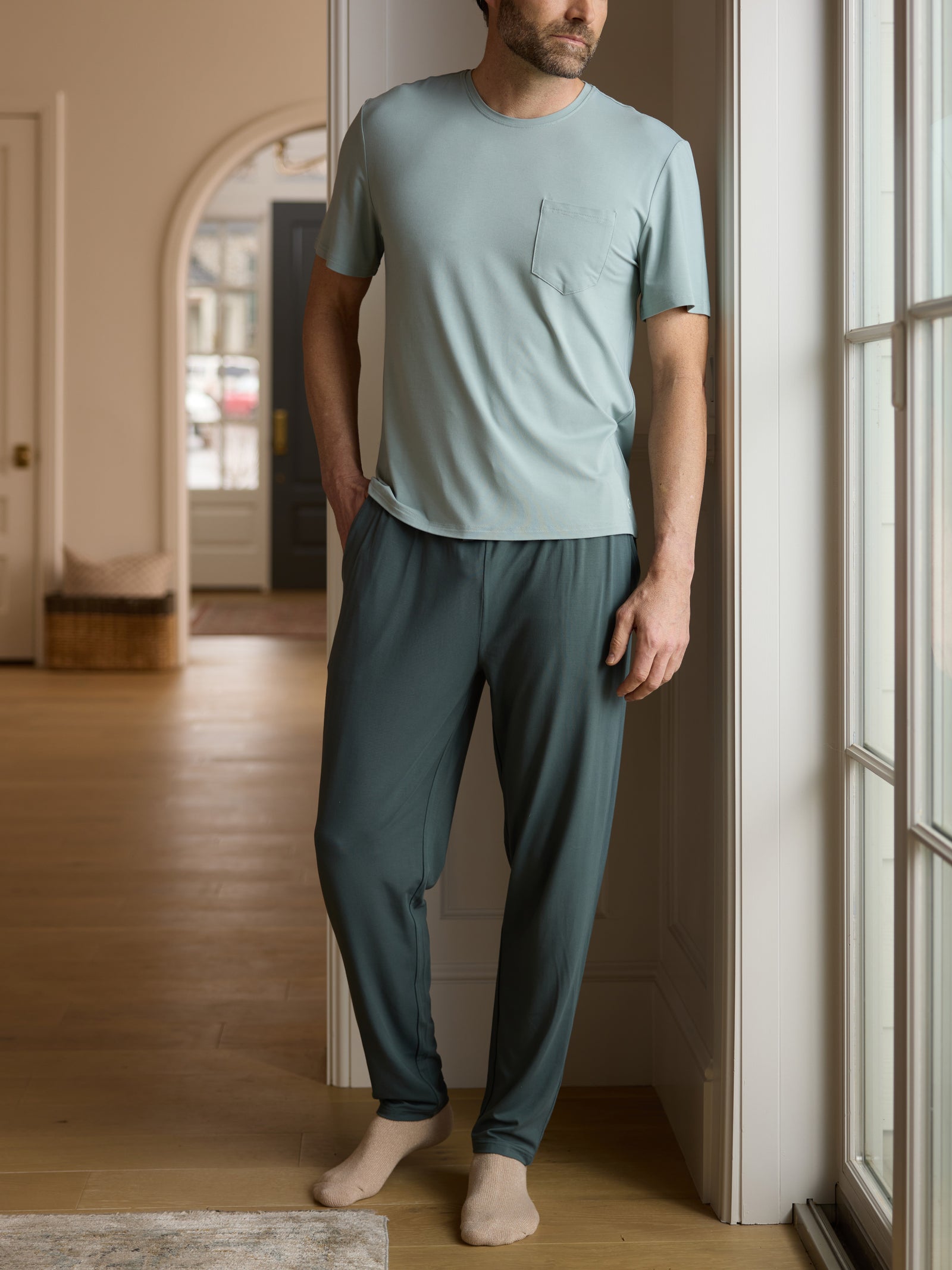 Man standing in hallway wearing storm pajama pants 