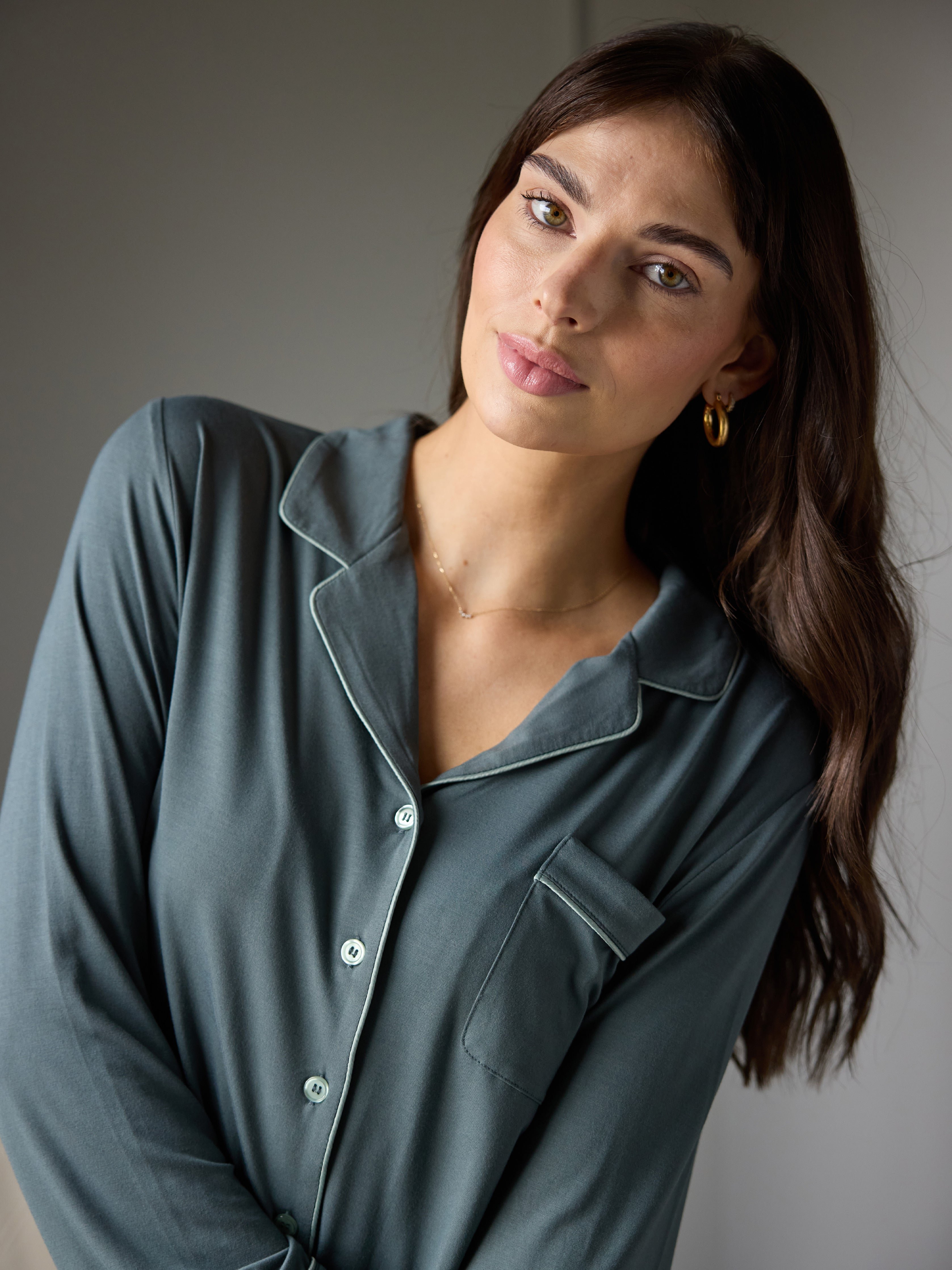 Woman wearing storm pajama shop with dark background 