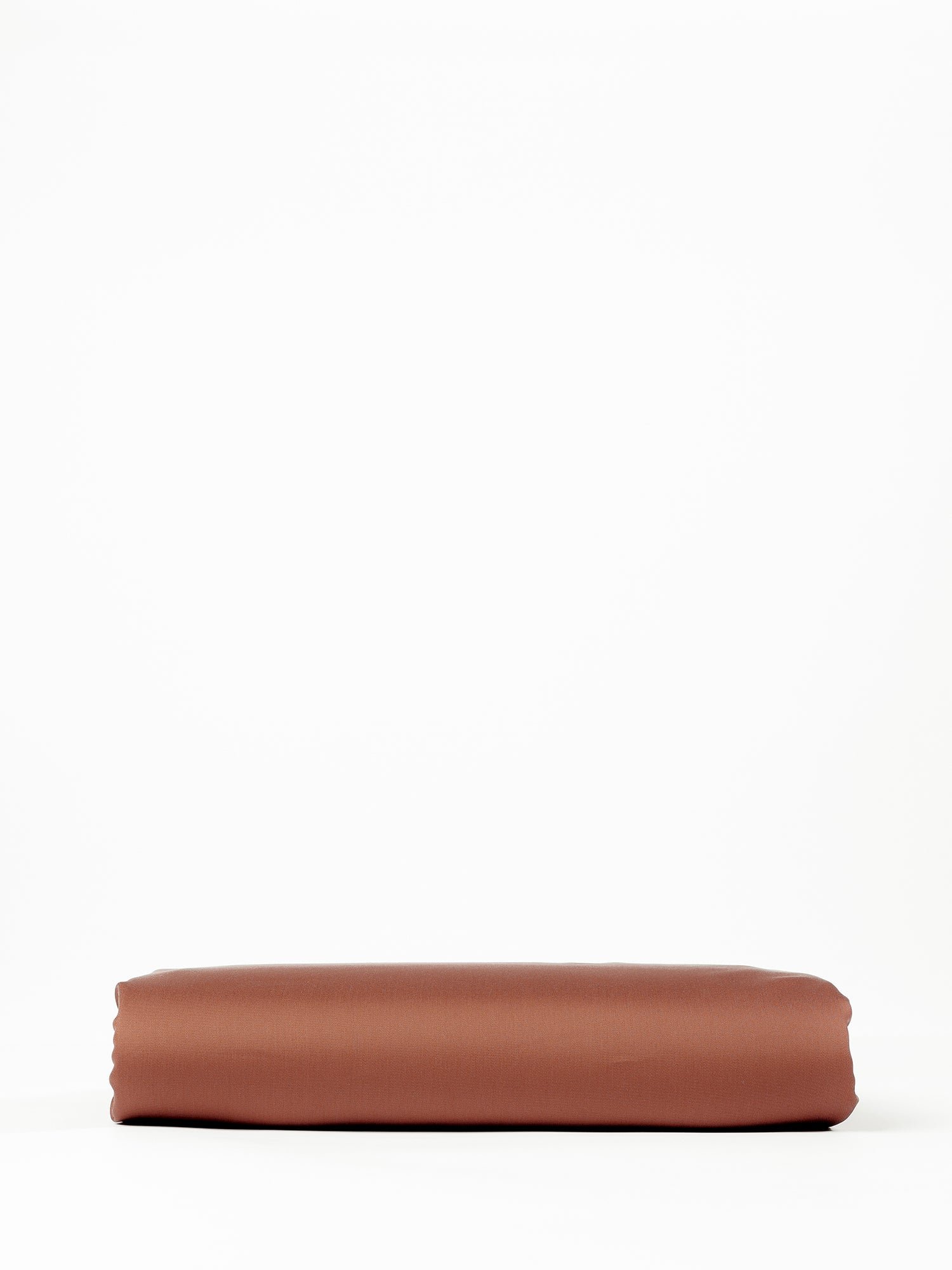 A neatly folded Bamboo Fitted Sheet from Cozy Earth, displayed against a plain white background. The sheet appears to be smooth and rectangular, resting flat with clean, defined edges. 