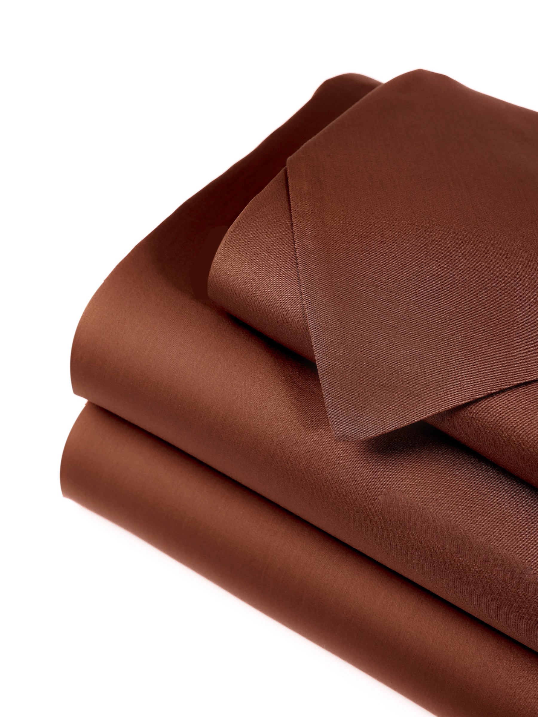 A neatly folded stack of Cozy Earth's Bamboo Sheet Set - Wholesale, in a rich dark brown color, including a pillowcase, displayed against a white background. The fabric appears smooth and soft, indicating its high-quality material. |Color:Terra