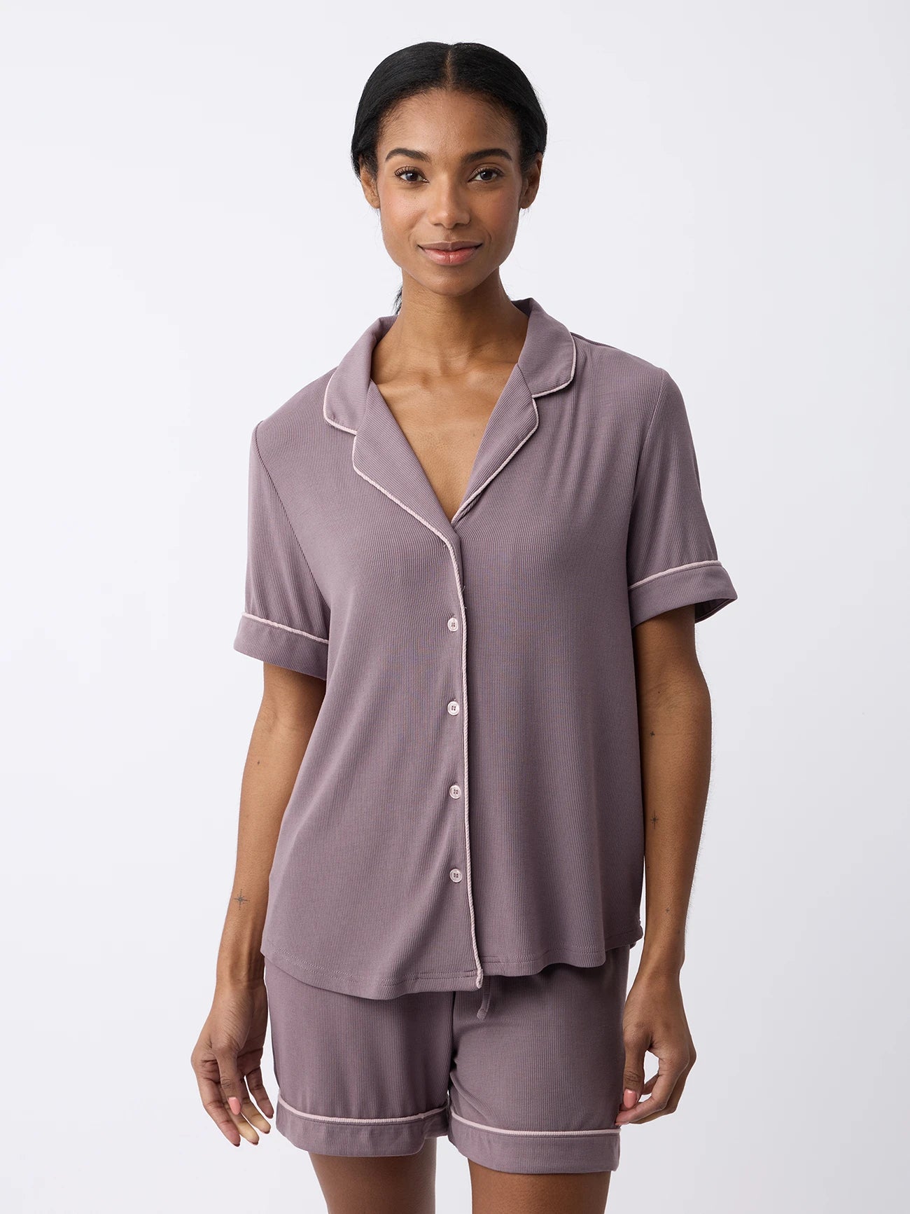 A woman in a Cozy Earth Twilight short-sleeved bamboo rib-knit pajama top with matching shorts stands against a plain white background. |Color:Twilight