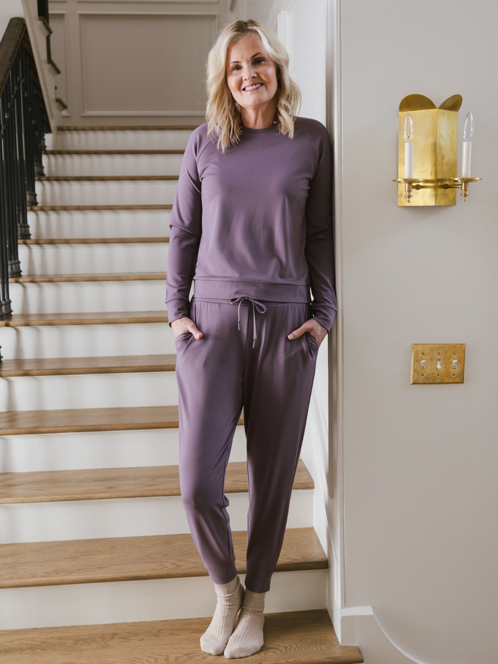 Twilight Bamboo Jogger Set modeled by a woman. The photo was taken in a high contrast setting, showing off the colors and lines of the pajamas. 