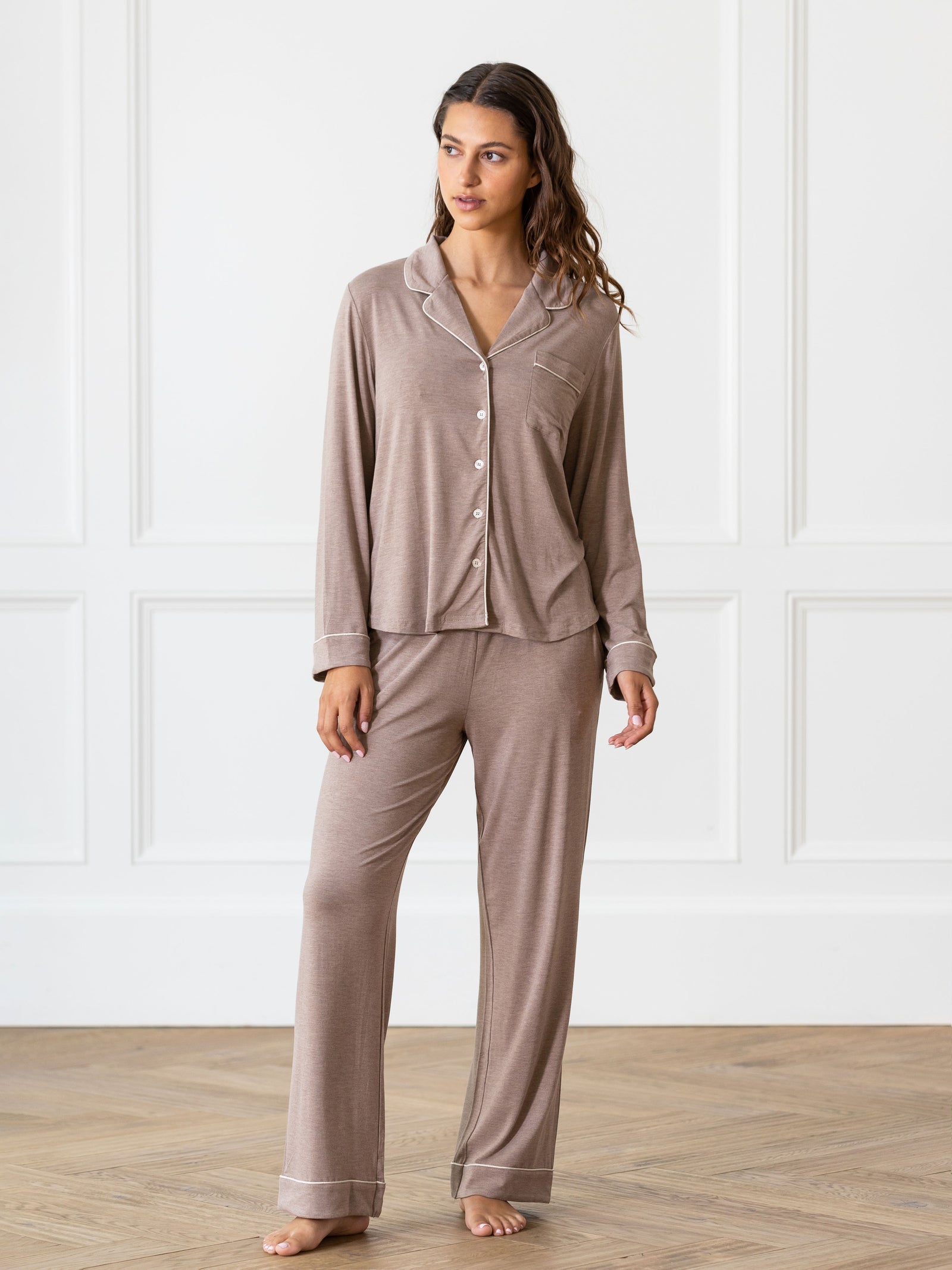 Walnut Long Sleeve Pajama Set modeled by a woman. The photo was taken in a light setting, showing off the colors and lines of the pajamas. 