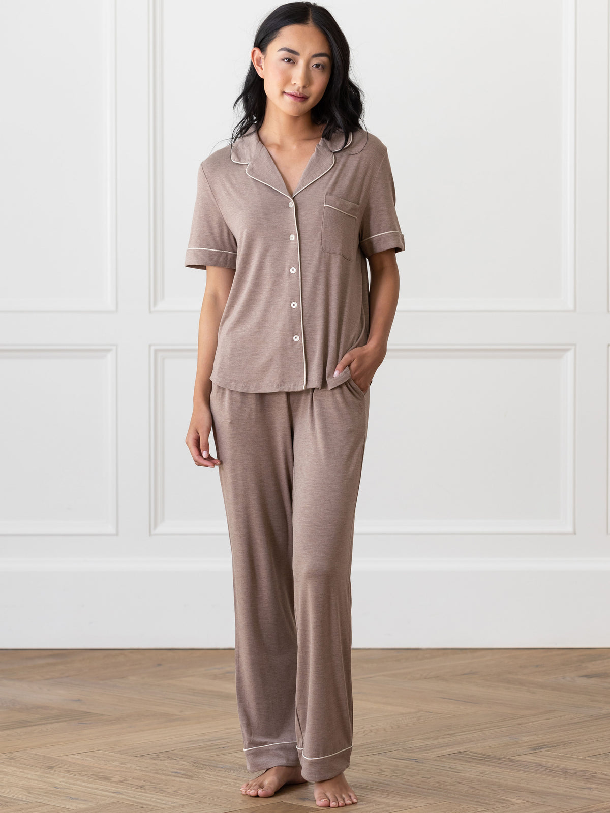 Walnut Short Sleeve & Pant Bamboo Pajama Set modeled by a woman. The photo was taken in a high contrast setting, showing off the colors and lines of the pajamas. 