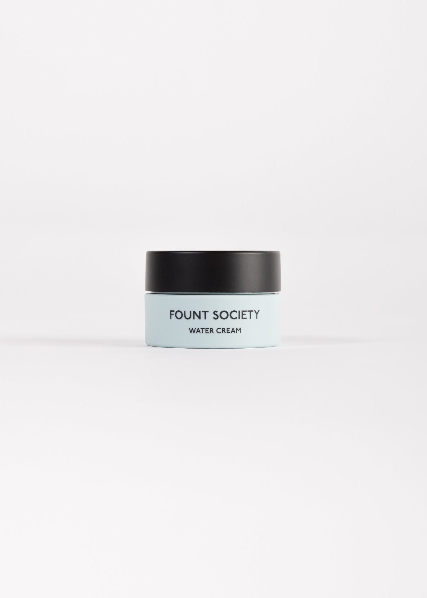 A small, light blue cosmetic jar with a black lid labeled "Cozy Earth Water Cream Moisturizer," centered on a white background. 