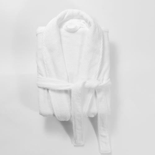 A Cozy Earth Ribbed Terry Bath Robe, in white and plush material, is neatly folded with its belt tied at the front and placed against a plain white background. |Color:White