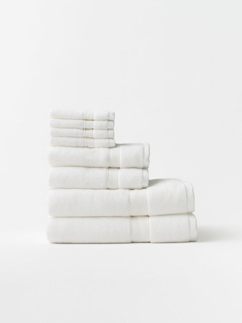White luxe bath towel set folded with white background