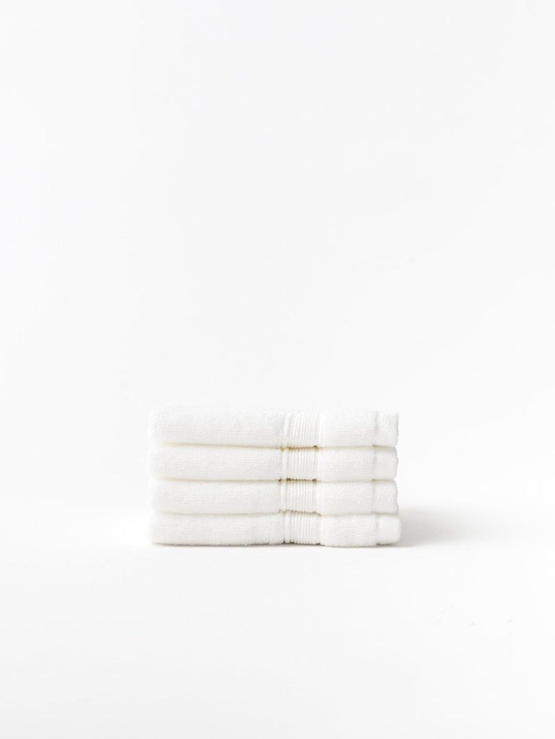 White luxe washcloths folded with white background