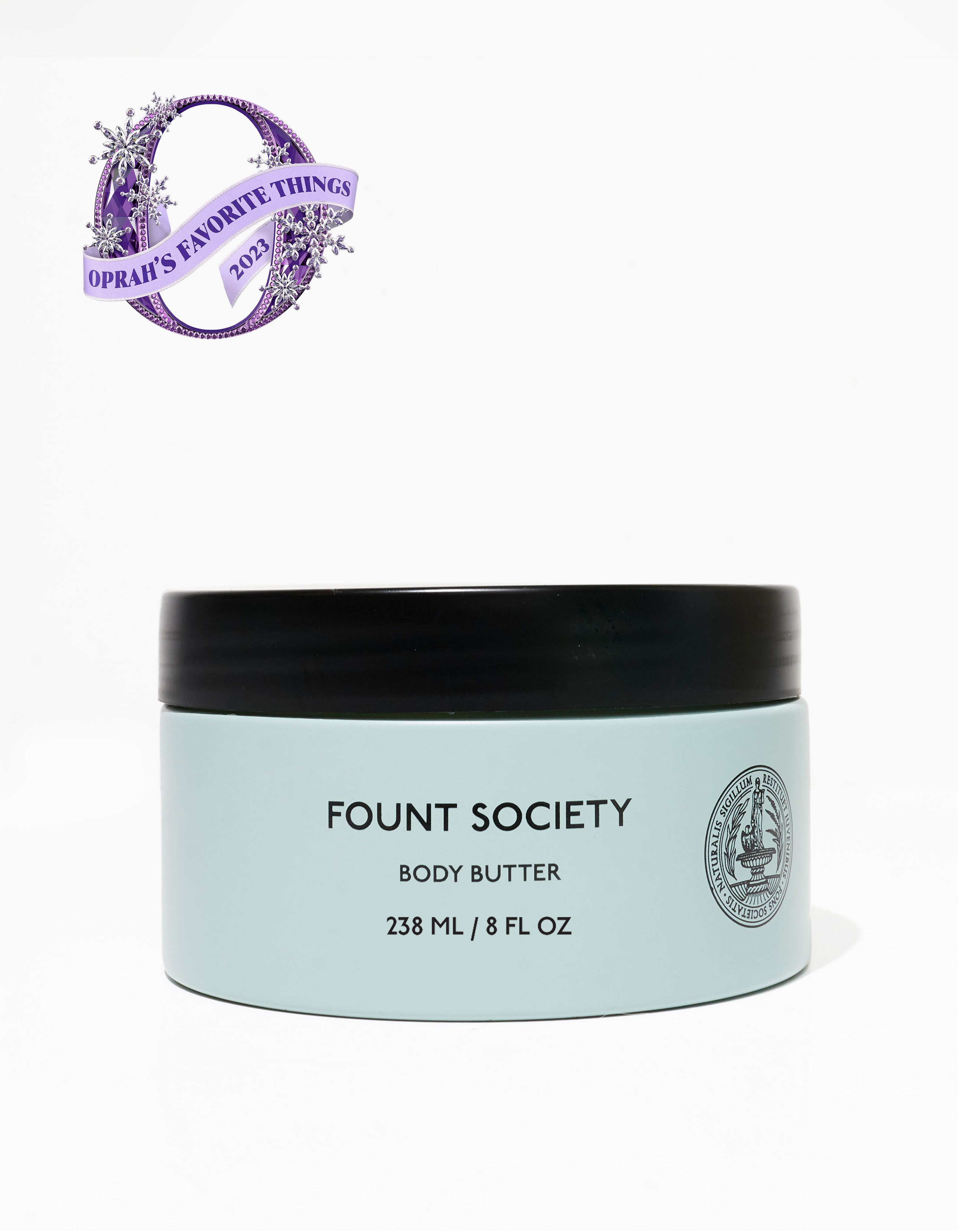A photo of a light blue jar of body butter from Cozy Earth with a black lid. The front label has the text "COZY EARTH BODY BUTTER 238 ML / 8 FL OZ." An emblem beside it shows it as one of "OPRAH'S FAVORITE THINGS 2023."
