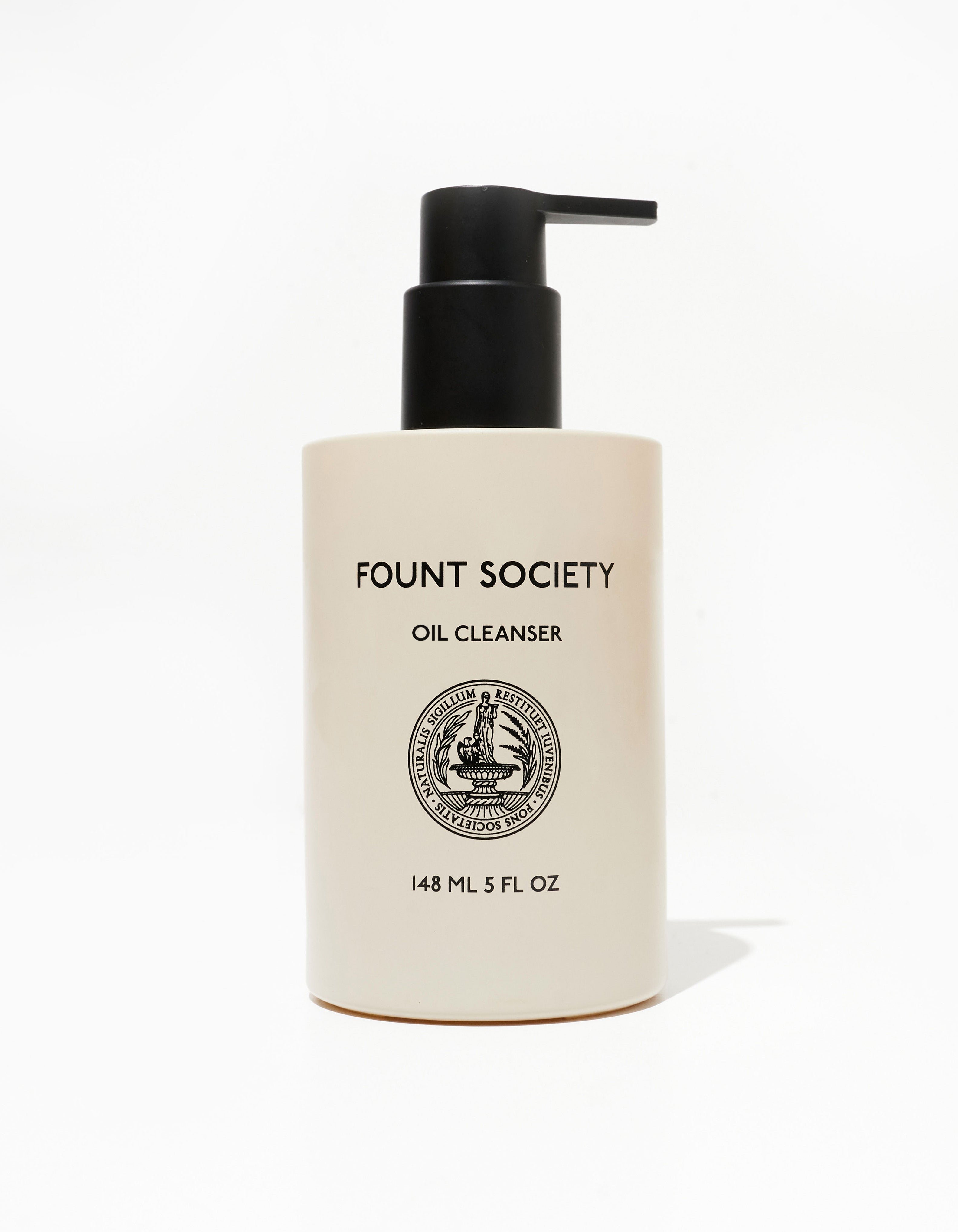 A beige cylindrical pump bottle labeled "COZY EARTH REVITALIZING PAIR" with a detailed round emblem in the center. The bottle contains 148 ml (5 fl oz) of product, and the pump is black. The background is plain white.