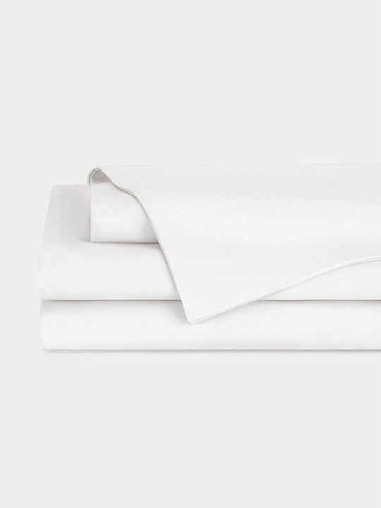 White Bamboo Linen Sheet Set neatly folded over a white background. 