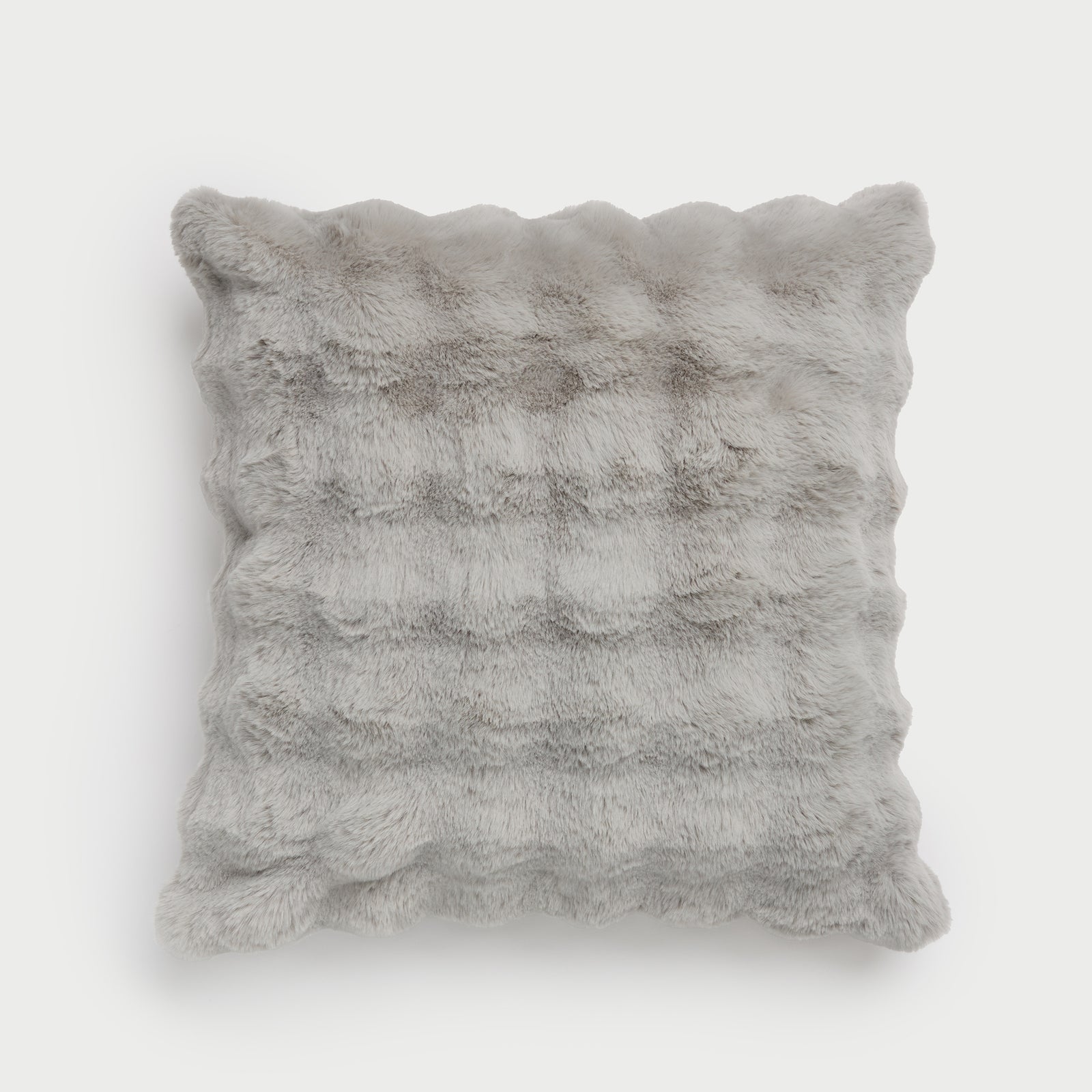 The Bubble Cuddle Pillow by Cozy Earth, featuring a square shape and a wavy, textured surface in grey faux fur, is displayed against a plain white background. 