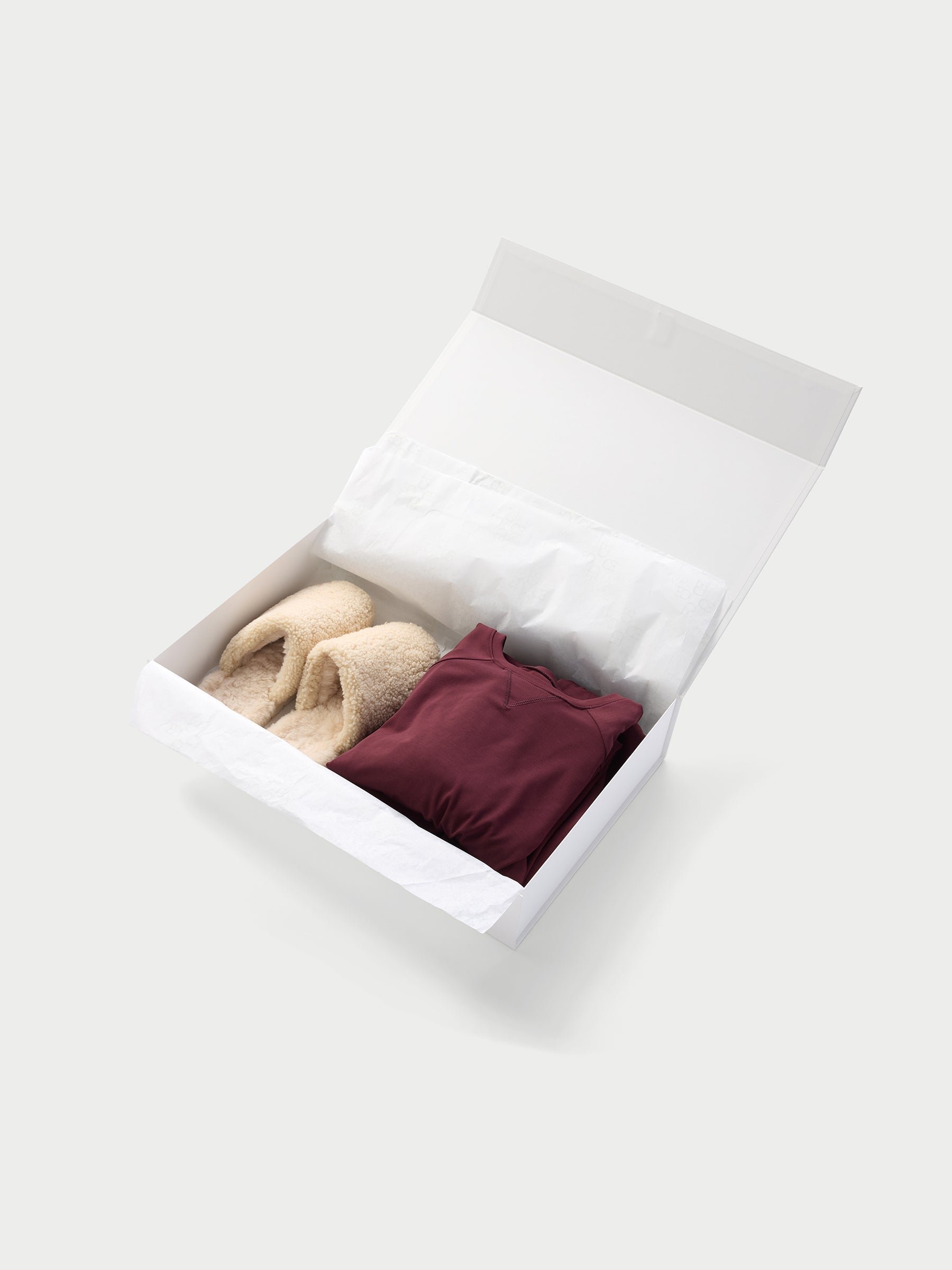 Large gift box open with cozy earth products inside 