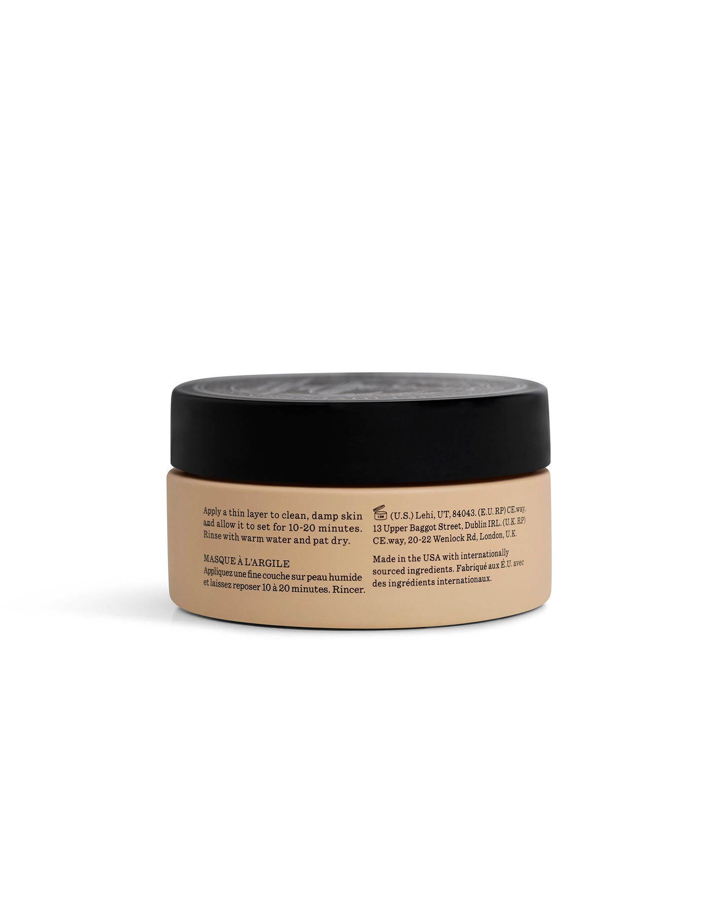 A beige jar labeled "Clay Mask" by Cozy Earth, with a black lid, is shown from the side. Black text on the jar displays product instructions and info, highlighting its use as a skincare item.